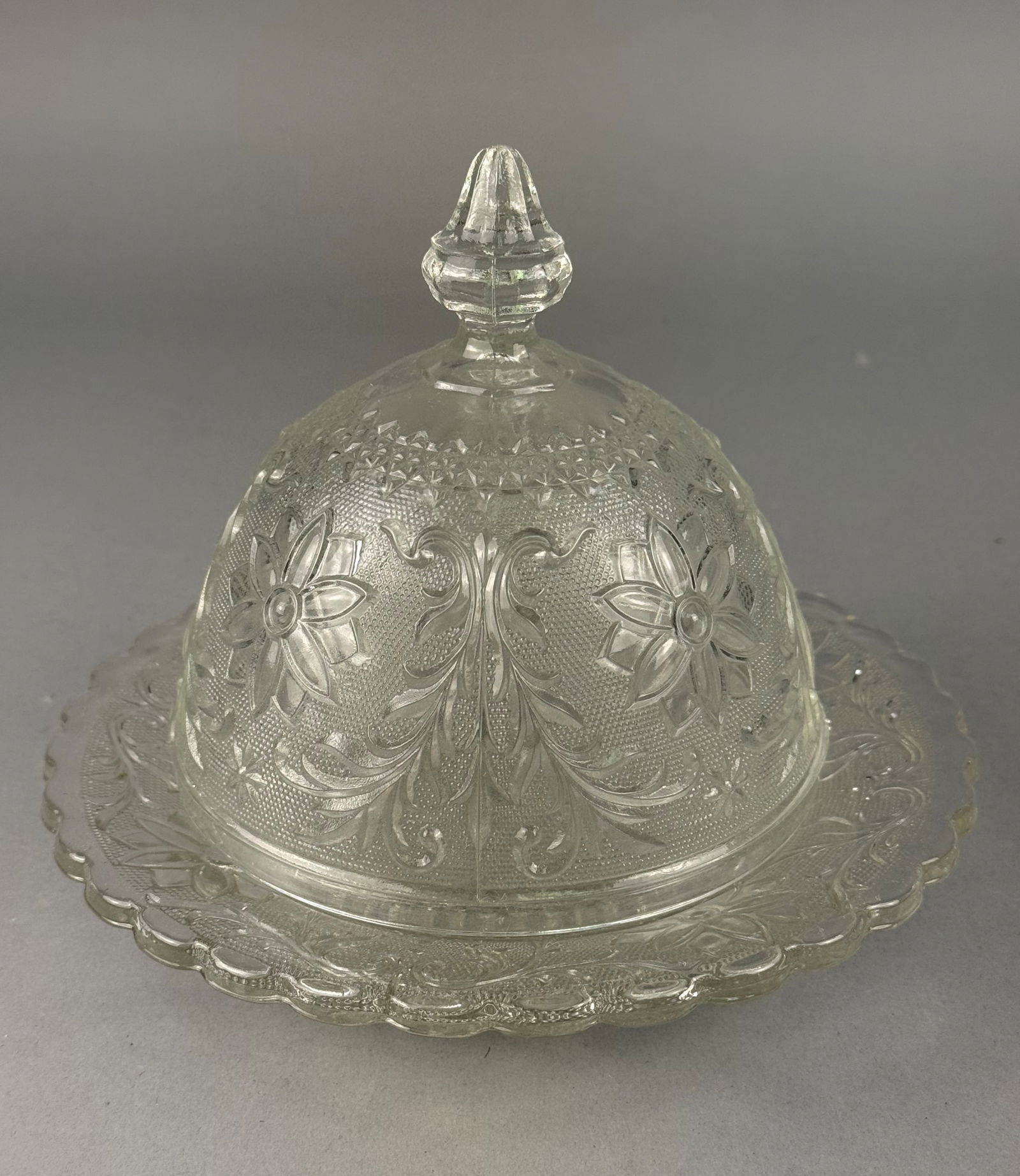 Tiara Exclusives Sandwich Pattern Crystal Glass Covered Butter Dish: This two-piece covered butter dish was marketed by Tiara Exclusives and likely manufactured by the Indiana Glass Company during the mid-to-late 20th century. The set is crafted from machine-pressed cl