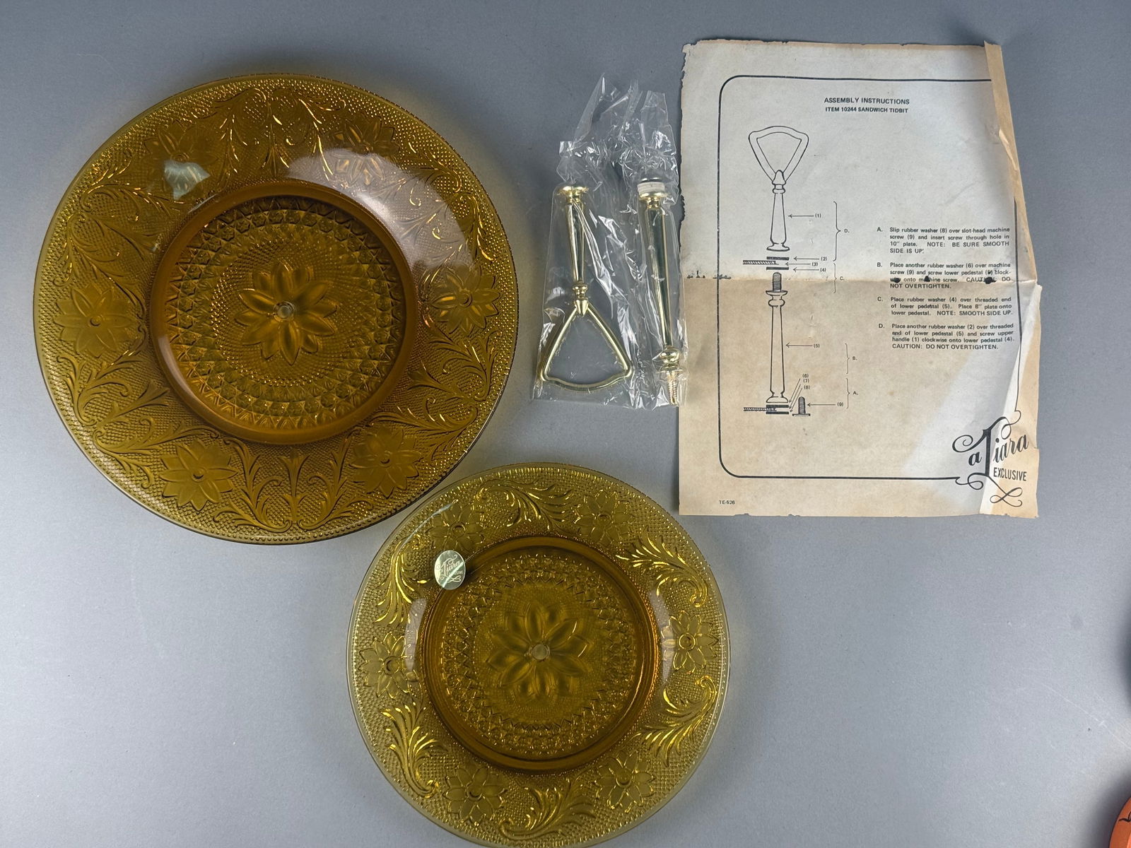 Tiara Exclusive Amber Sandwich Pattern Two-Tier Tidbit Server with Original Box: This two-tier "Sandwich Tidbit" server set is produced in amber-colored pressed glass, featuring the classic Sandwich pattern characterized by intricate molded floral, scroll, and stippled m