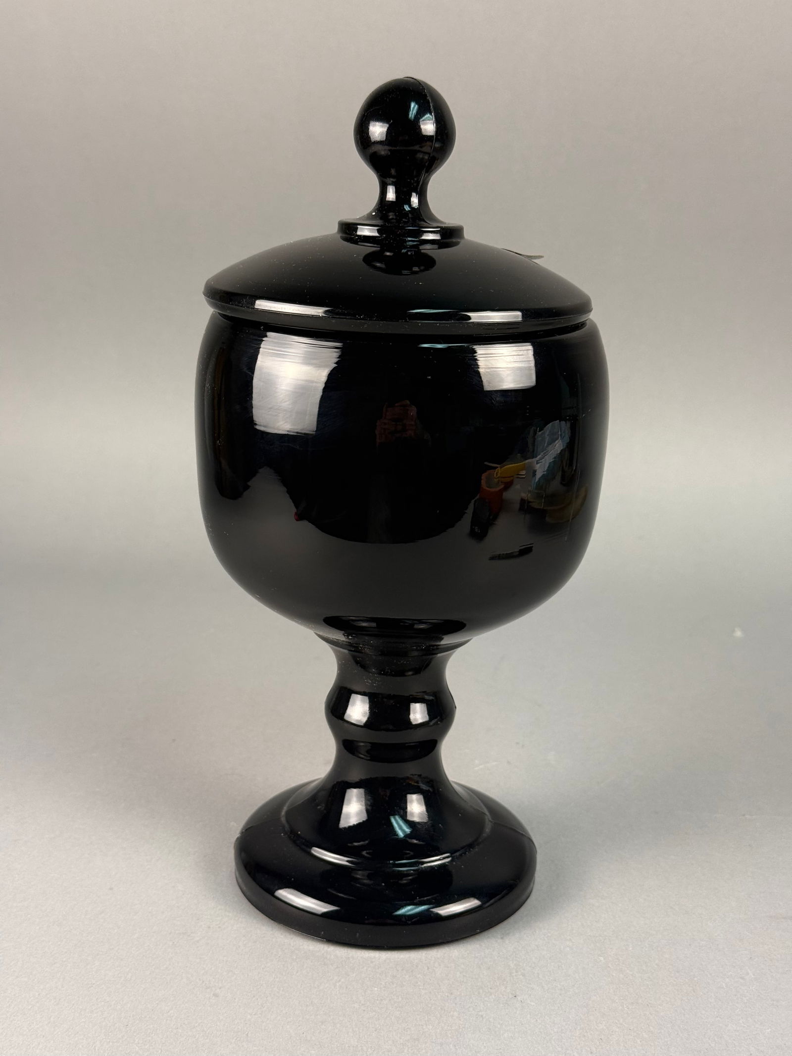 Tiara Exclusives, Pressed Opaque Glass, Pedestal Candy Dish: A vintage two-piece pedestal candy dish with a matching domed lid, distributed by Tiara Exclusives. The piece is crafted from solid opaque black glass using a pressed glass technique, featuring visibl