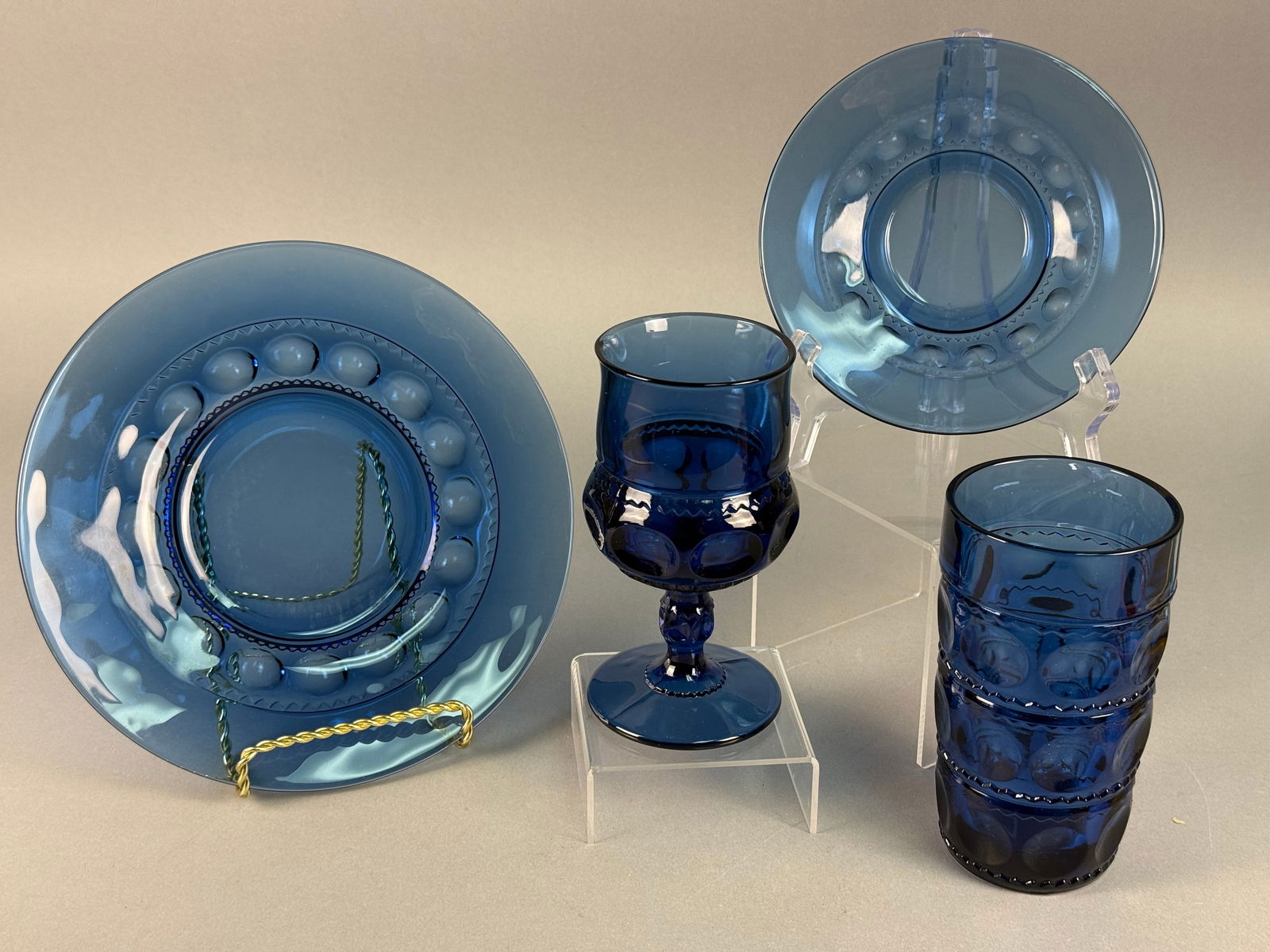 Tiara Exclusives, Pressed Glass, Place Setting Cobalt Blue: A four-piece place setting produced by the Indiana Glass Company for Tiara Exclusives in the Dew Drop pattern. The set is crafted from deep cobalt blue pressed glass, featuring the pattern's signature
