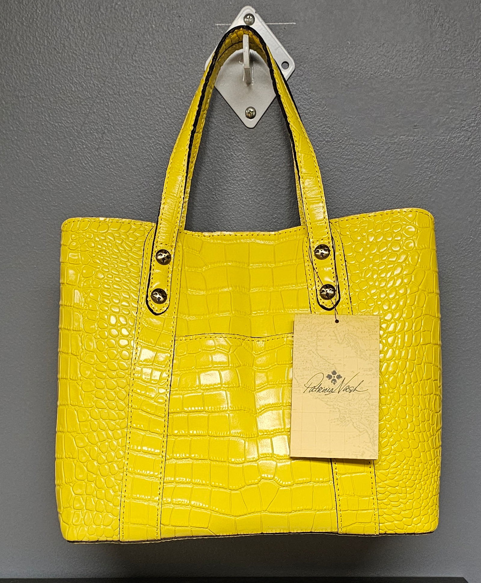 Patricia Nash Darby Tote, New Yellow Distressed Vintage Croc Embossed Leather: This Patricia Nash Darby Tote C/B is part of the Distressed Vintage Croc collection, crafted from embossed croc leather in a vibrant New Yellow color. The handbag features dual top handles with visibl