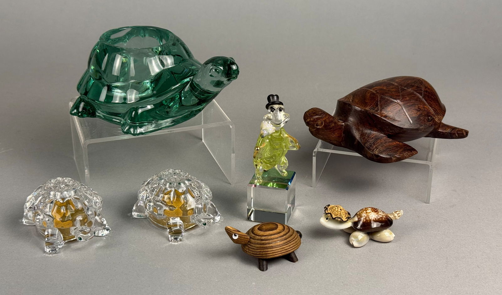 A Collection of Decorative Turtle Figurines Including Indiana Glass and Lenox Crystal: A collection of turtle-themed decorative objects featuring an Indiana Glass green translucent glass votive candle holder. The group includes a pair of Lenox full lead crystal figurines with faceted sh