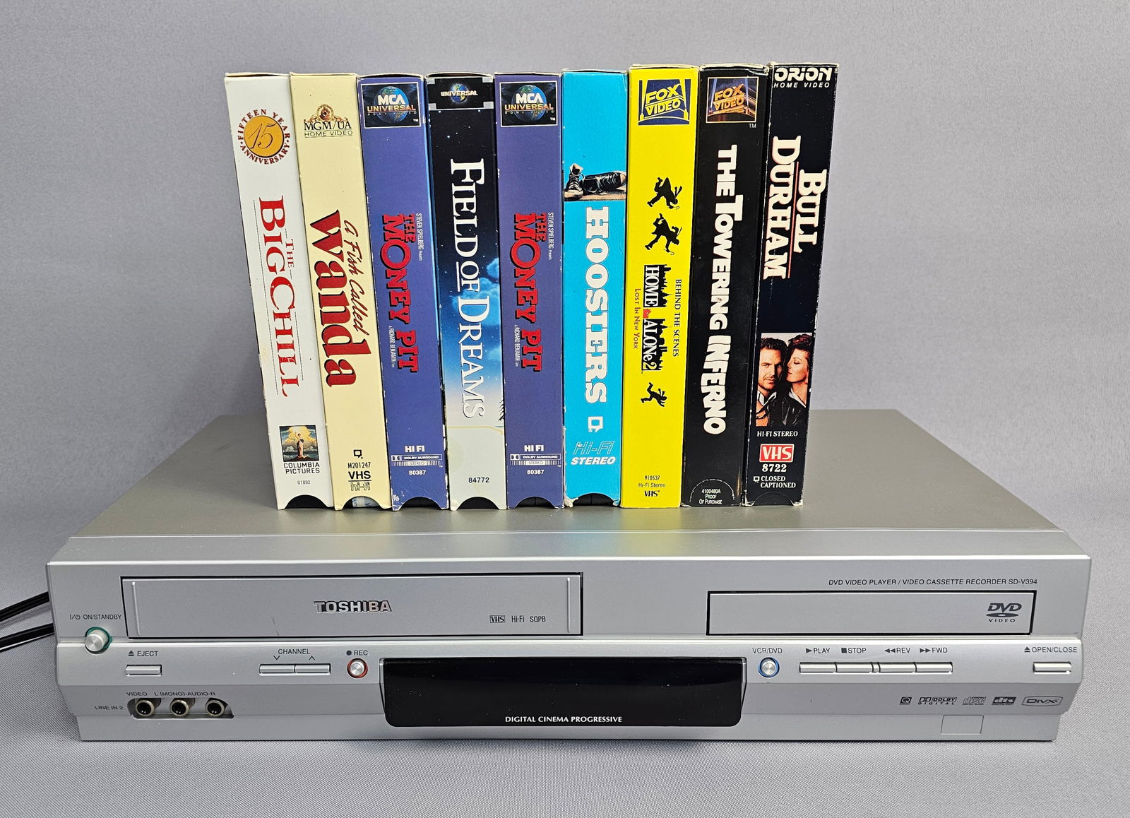 Toshiba, SD-V394SU DVD/VCR Combo Deck with Owner's Manual and VHS Cinema Collection: Toshiba Corporation, Model SD-V394SU DVD Video Player / Video Cassette Recorder. Manufactured September 2006, Thailand. This lot includes the original English language Owner's Manual and a collection