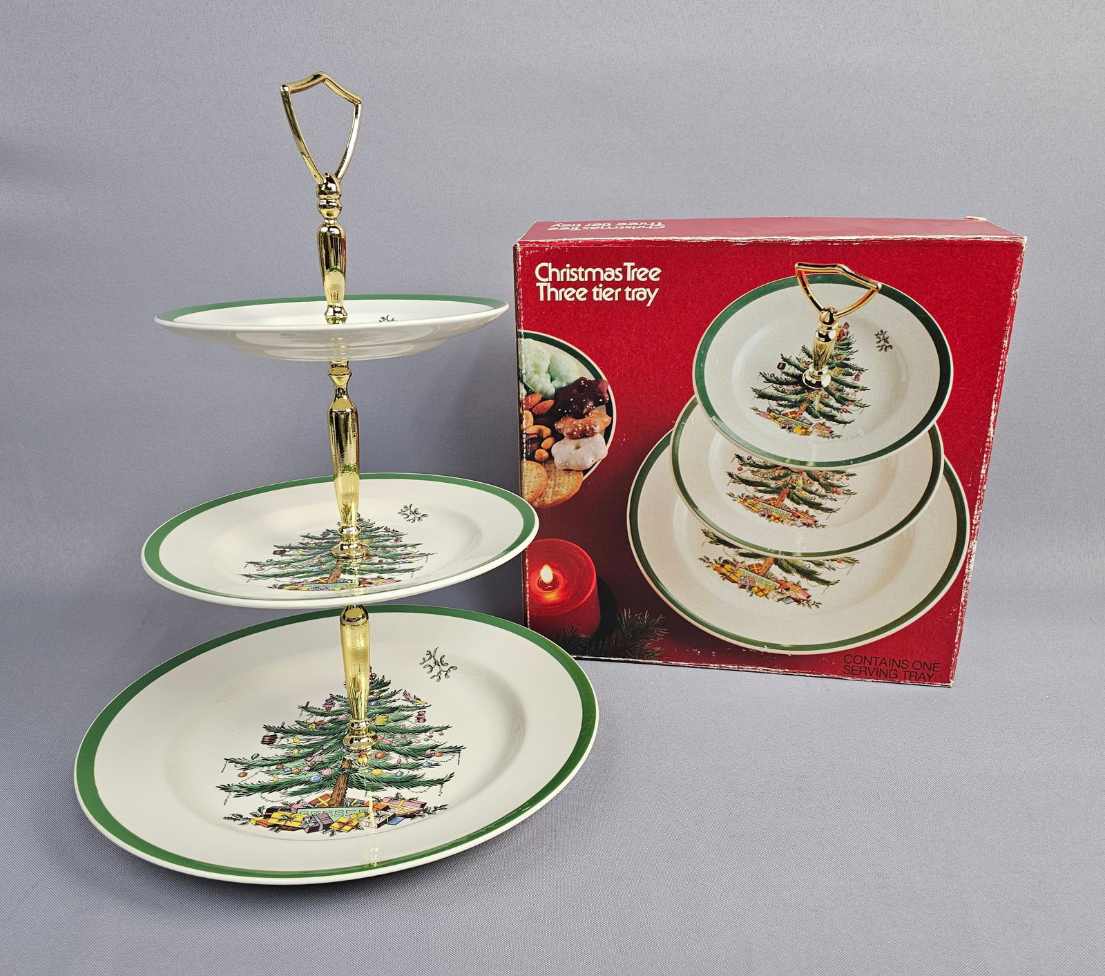 Spode Christmas Tree Pattern Three-Tier Ceramic Serving Tray with Original Box: A three-tier serving tray produced by Spode in the celebrated Christmas Tree pattern. This set is crafted from glazed earthenware and features the iconic central motif of a decorated holiday tree