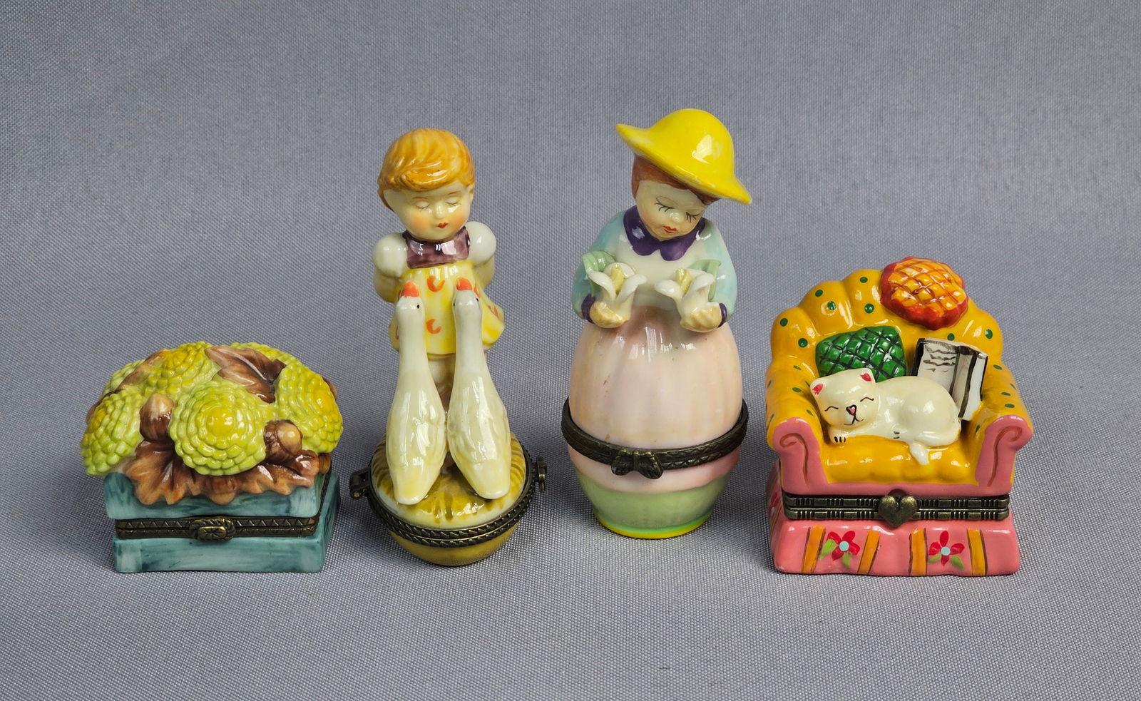 Vintage Porcelain Trinket Box Collection: This collection features four hand-painted glazed porcelain hinged trinket boxes designed in the Limoges style. The motifs include a rectangular box with relief yellow chrysanthemums, a figural box