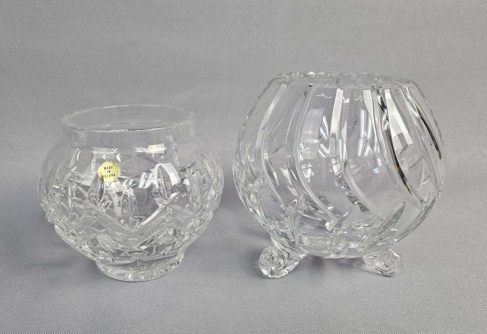 A Pair of Lead Crystal Bowls: This lot consists of two high-quality decorative crystal items. The first is a hand-cut lead crystal rose bowl of globular form, manufactured in Poland. The exterior is intricately decorated with