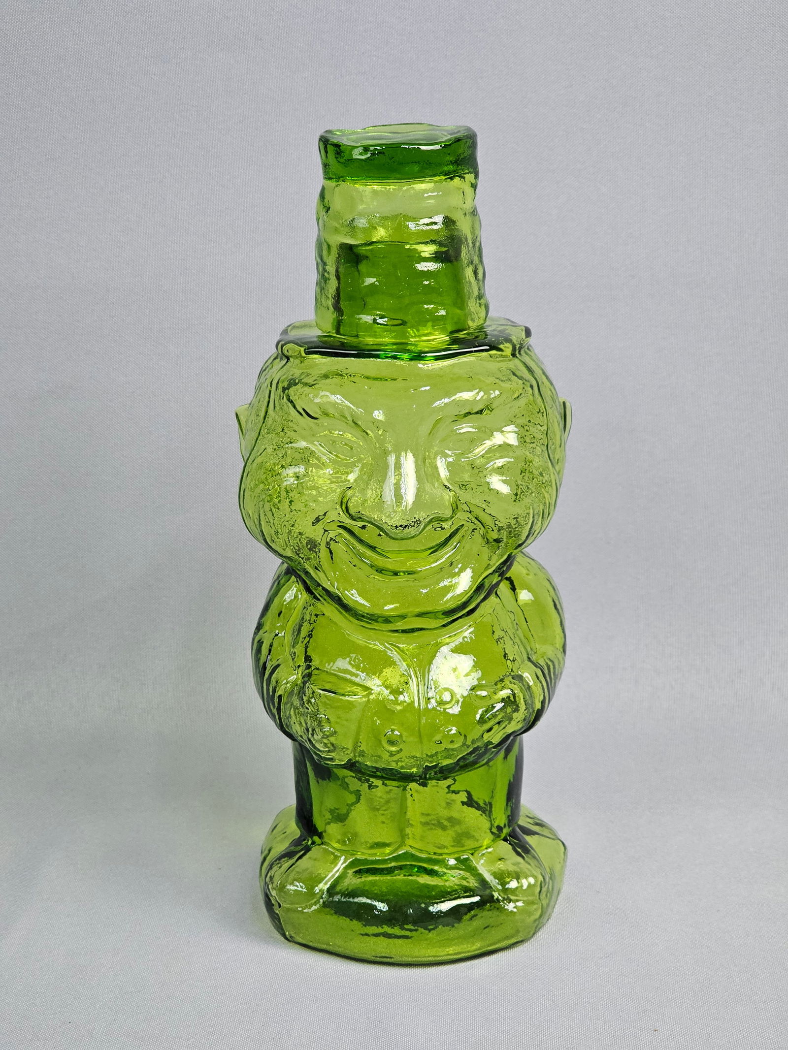 Vintage Indiana Glass Old Mountaineer Decanter Set: A mid-century modern decorative glass decanter set. The set is rendered in a vibrant transparent avocado green glass with a highly textured, pebbled surface. The decanter is accompanied by a matching