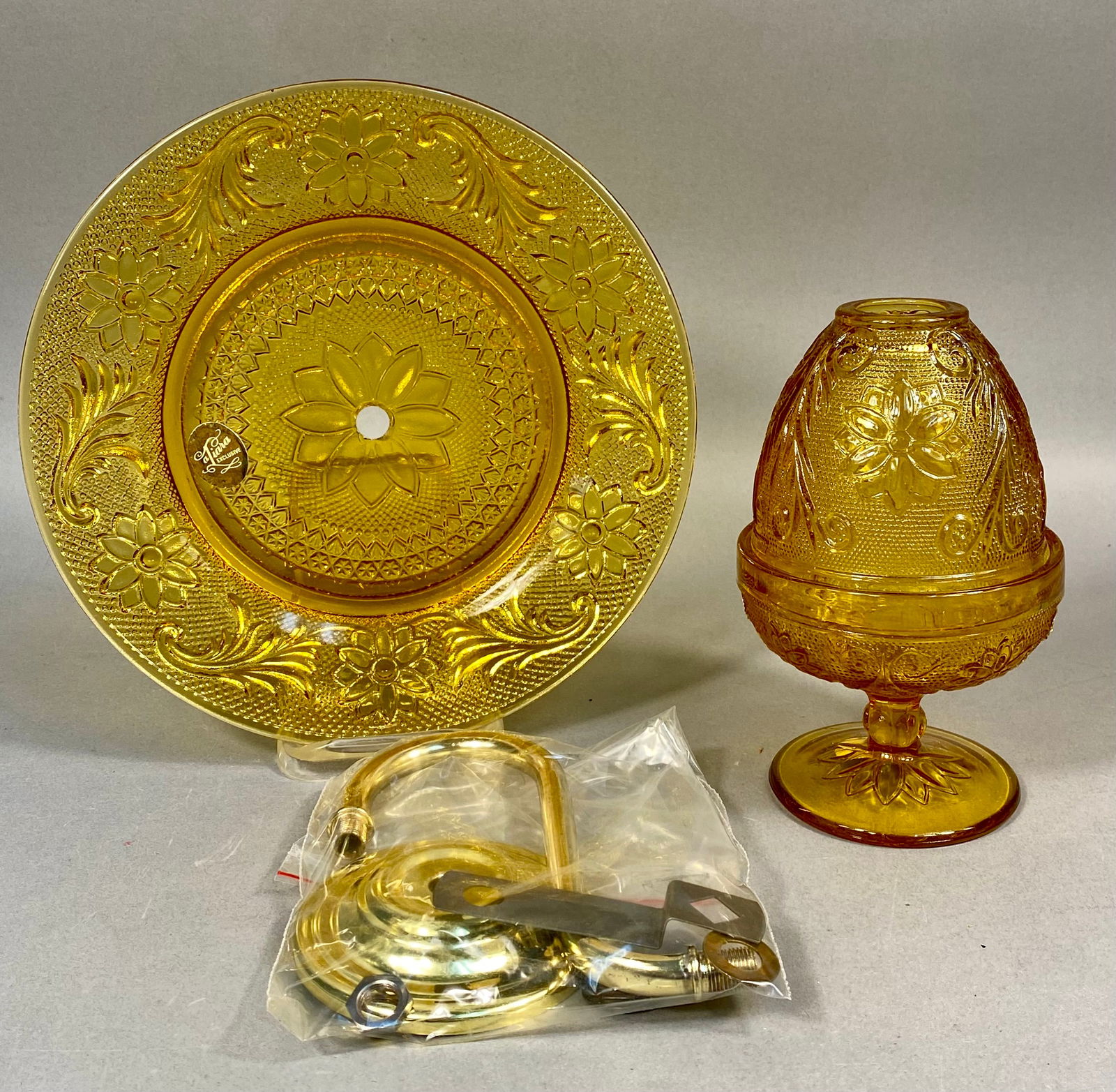 Tiara Exclusives Sandwich Pattern Amber Glass Wall Sconce: Produced by the Indiana Glass Company for Tiara Exclusives, this vintage wall sconce set is featured in the popular Sandwich pattern. The design is characterized by a traditional stippled background a