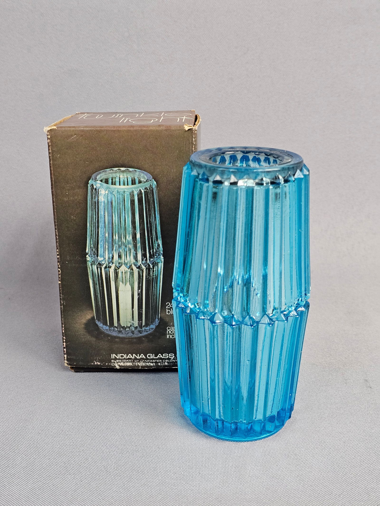 Indiana Glass Co. Pressed Glass 'Twinkle Light' Candle Holder Set: This lot features a vintage two-piece interlocking candle holder set manufactured by the Indiana Glass Company, a subsidiary of Lancaster Colony Corp. based in Dunkirk, Indiana. Identified as the &quo