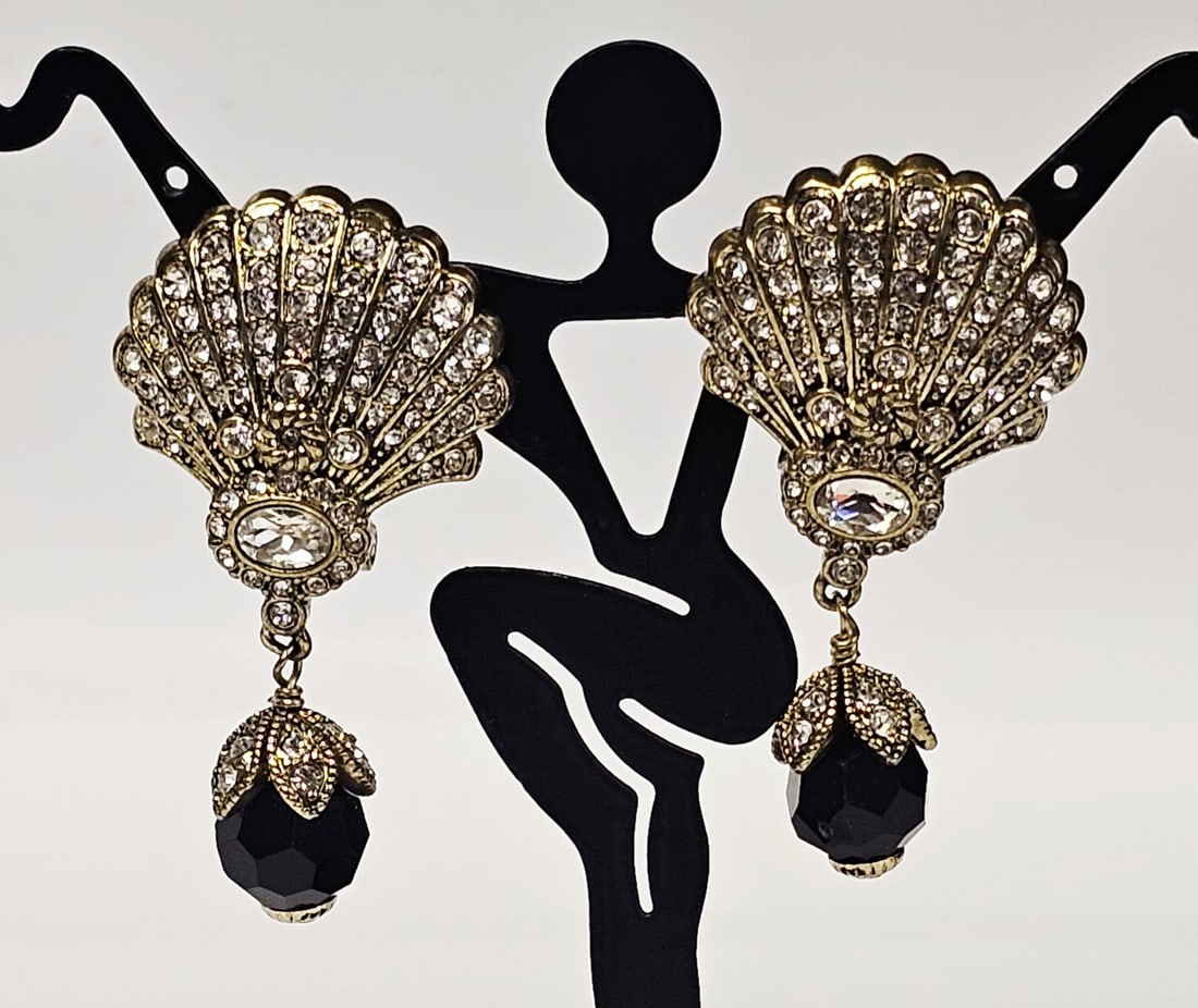 Heidi Daus Crystal and Black Bead Drop Earrings: This matched pair of drop earrings is produced by designer Heidi Daus. The earrings feature fan-shaped tops with a shell-like ribbed texture, pavé-set with numerous round colorless crystals and