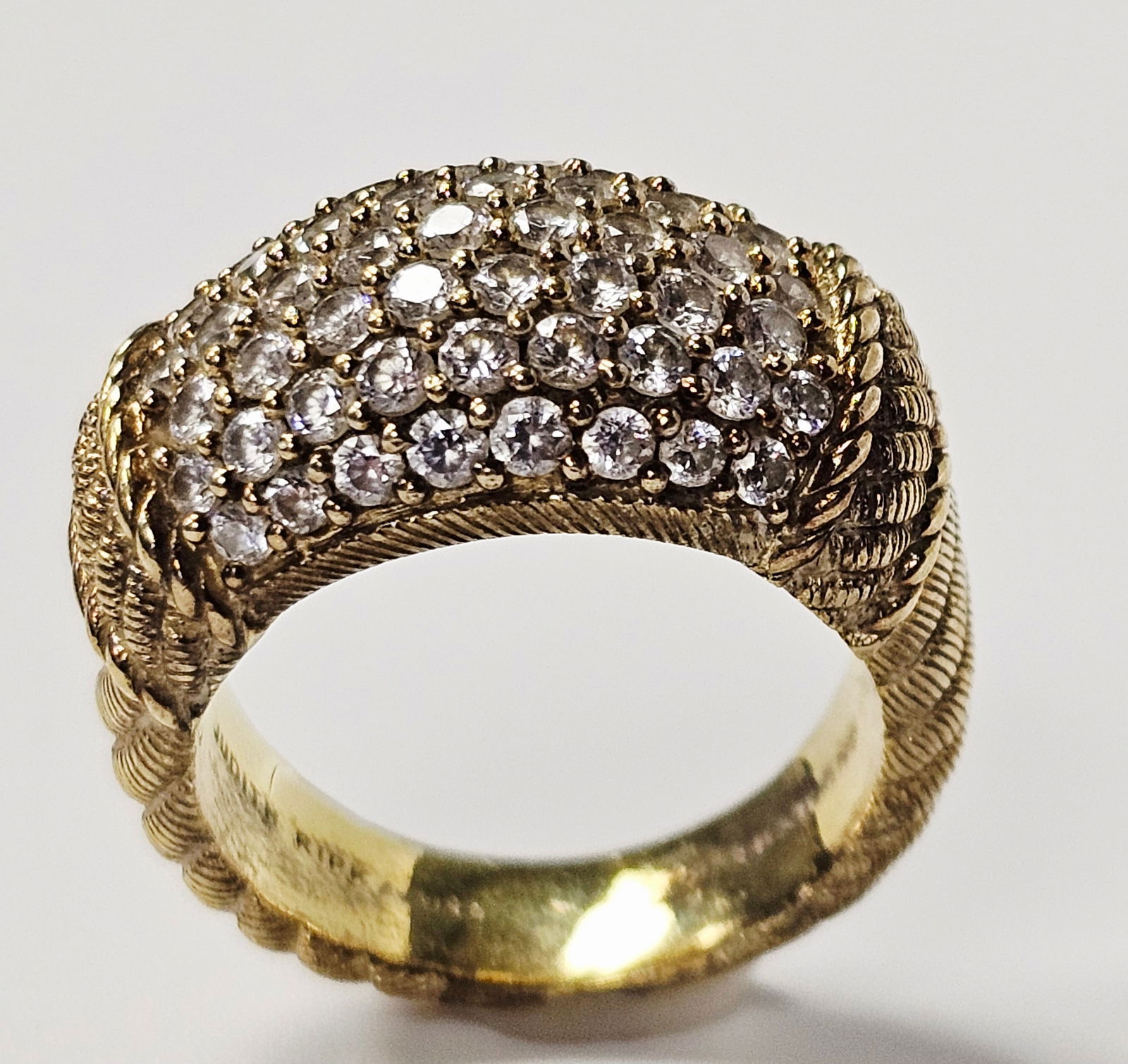Judith Ripka Sterling Vermeil CZ Ring 10.4 Grams: A statement cocktail ring designed by Judith Ripka. The ring is crafted from gold-toned sterling silver and features a prominent dome pavé-set with multiple rows of round-cut clear cubic zircon
