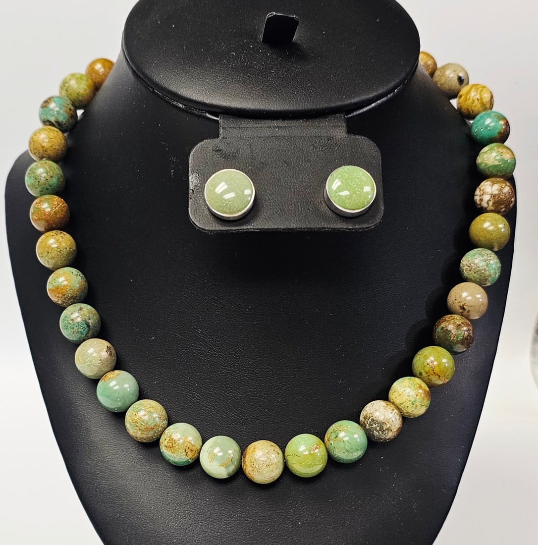 Sterling Multi-Color Stone Beaded Necklace & Earrings: This jewelry set includes a necklace and a pair of stud earrings, both fashioned from sterling silver. The necklace is composed of round, polished beads in mottled shades of green, tan, and brown. It