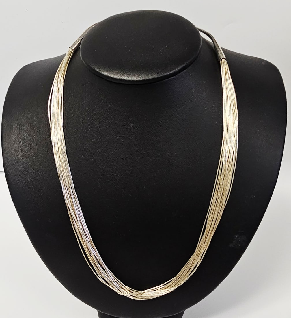 Running Bear Sterling Liquid Silver Necklace 18.3 Grams: This multi-strand necklace is produced by the Running Bear Shop of Gallup, New Mexico. The piece is constructed from numerous strands of liquid silver, consisting of fine, elongated cylindrical sterli