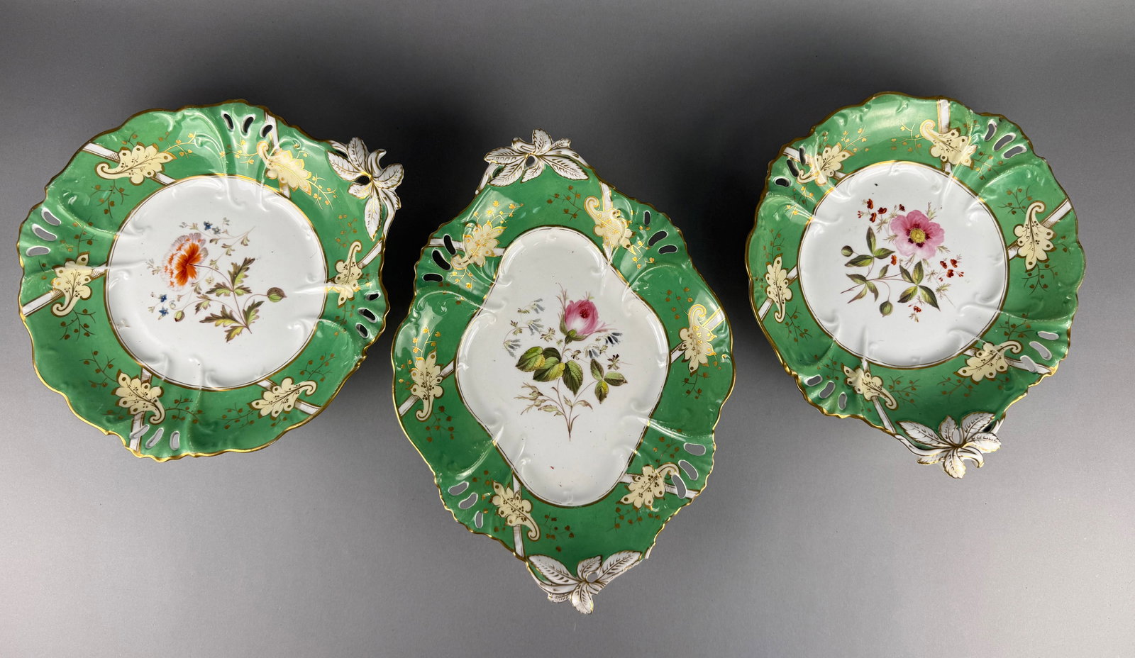 A Trio of Victorian Hand-Painted Porcelain Pedestal Dessert Dishes: A trio of Victorian-style porcelain pedestal dishes, possibly English and resembling the work of Samuel Alcock or similar Staffordshire potteries. The set comprises one oval twin-handled compote and t