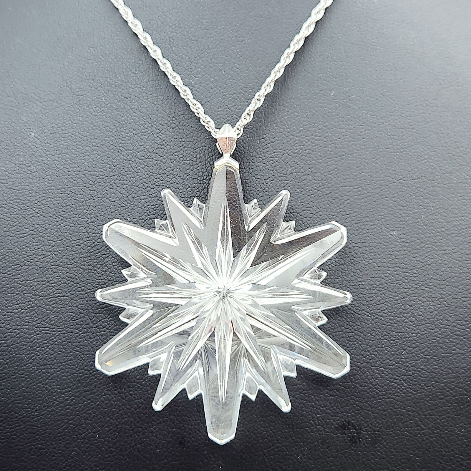 Gorham Crystal Pendant Sterling Chain 3.7 Grams: This pendant necklace features a large, multi-faceted star-shaped pendant crafted from clear cut crystal or glass. The pendant is designed with numerous radiating points and deep facets, resembling a