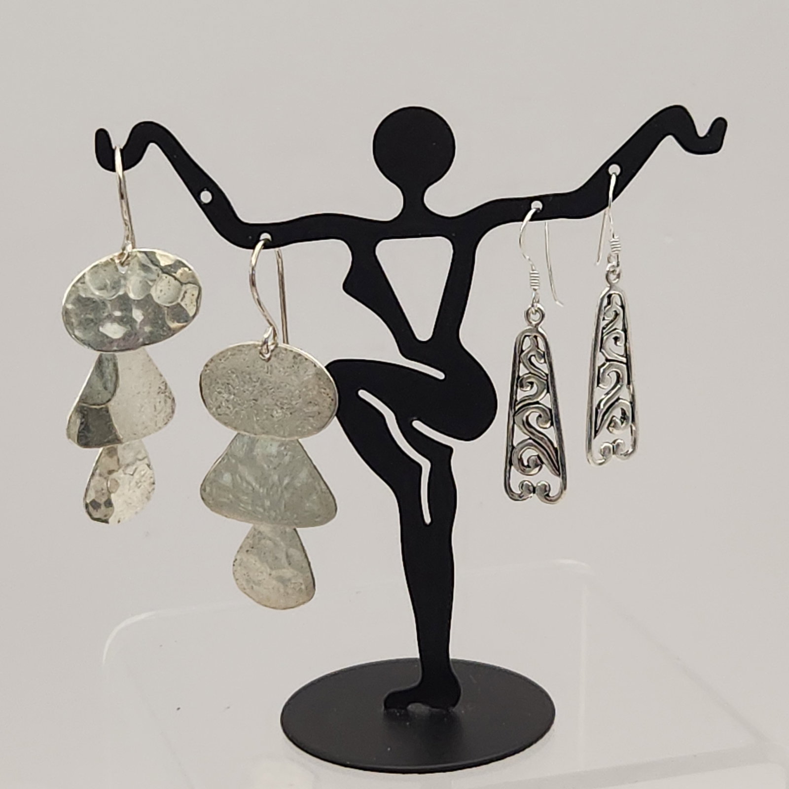 Two Pairs Sterling Earrings 9.3 Grams: Two pairs of sterling silver earrings marked 925 MC featuring hammered graduated organic shapes and an openwork scrollwork design, weighing approximately 9.3 grams and measuring 1.5 to 1.75 inches lon