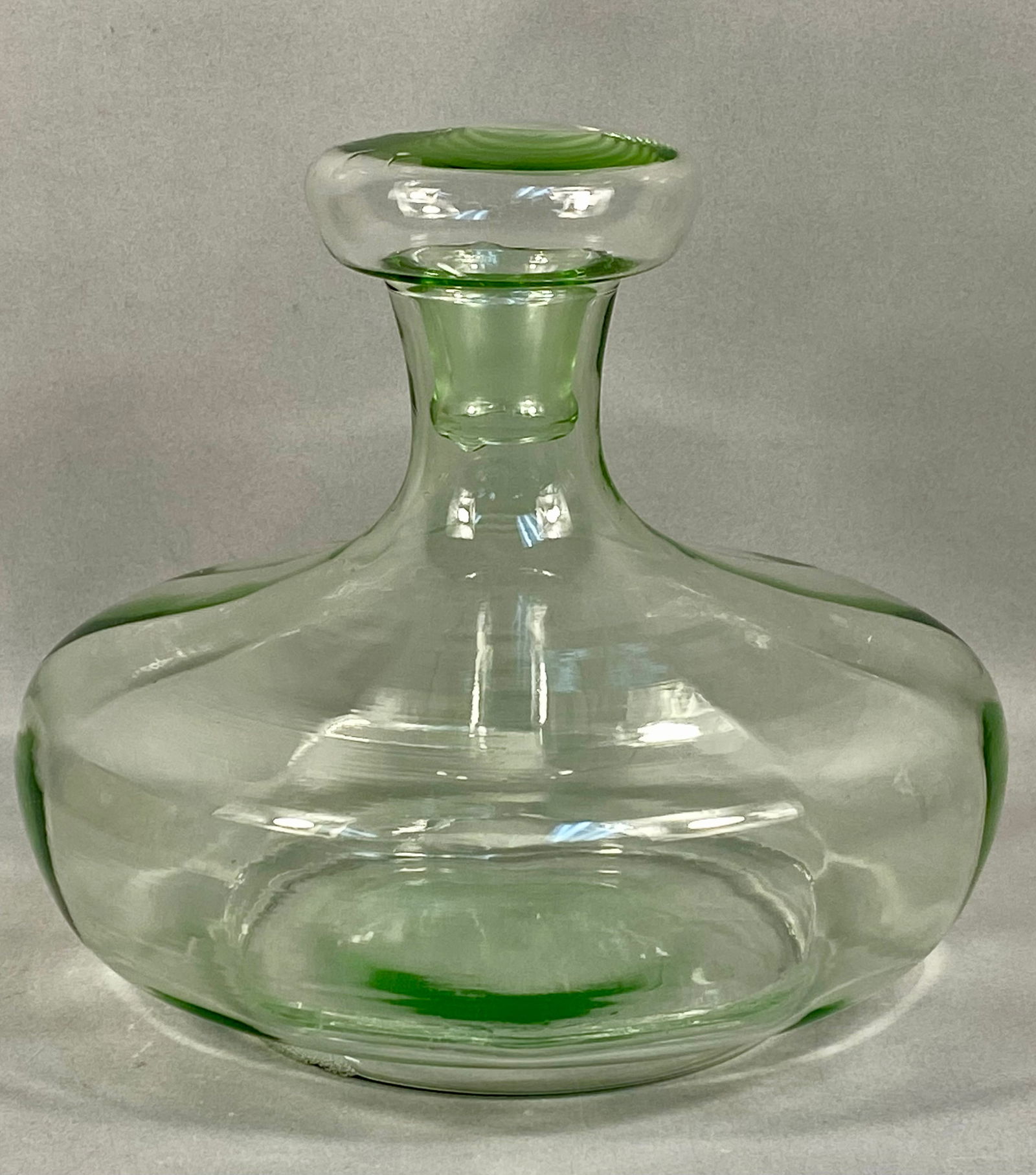 Tiara Exclusives Hand-Blown Glass Ship's Decanter and Stopper: This hand-blown glass ship's decanter is attributed to Tiara Exclusives, as evidenced by the original retail box. The vessel is crafted from apple green glass and features a characteristic ship's