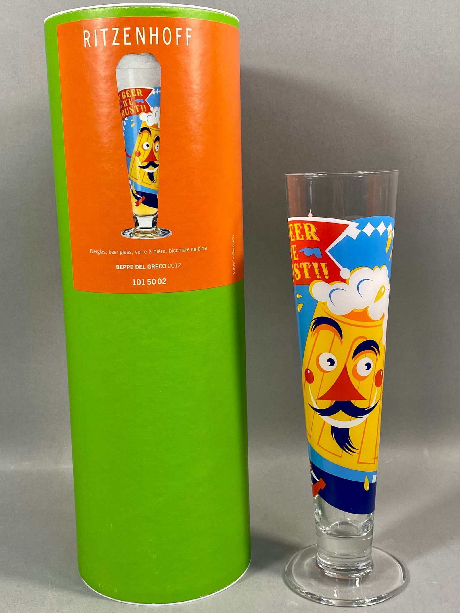 Ritzenhoff Beppe Del Greco Designer Beer Glass with Original Packaging: A tall, tapered pilsner-style beer glass manufactured by Ritzenhoff in Germany. The glass features a design by Italian architect and designer Beppe Del Greco, dated 2012. The clear glass body is decor