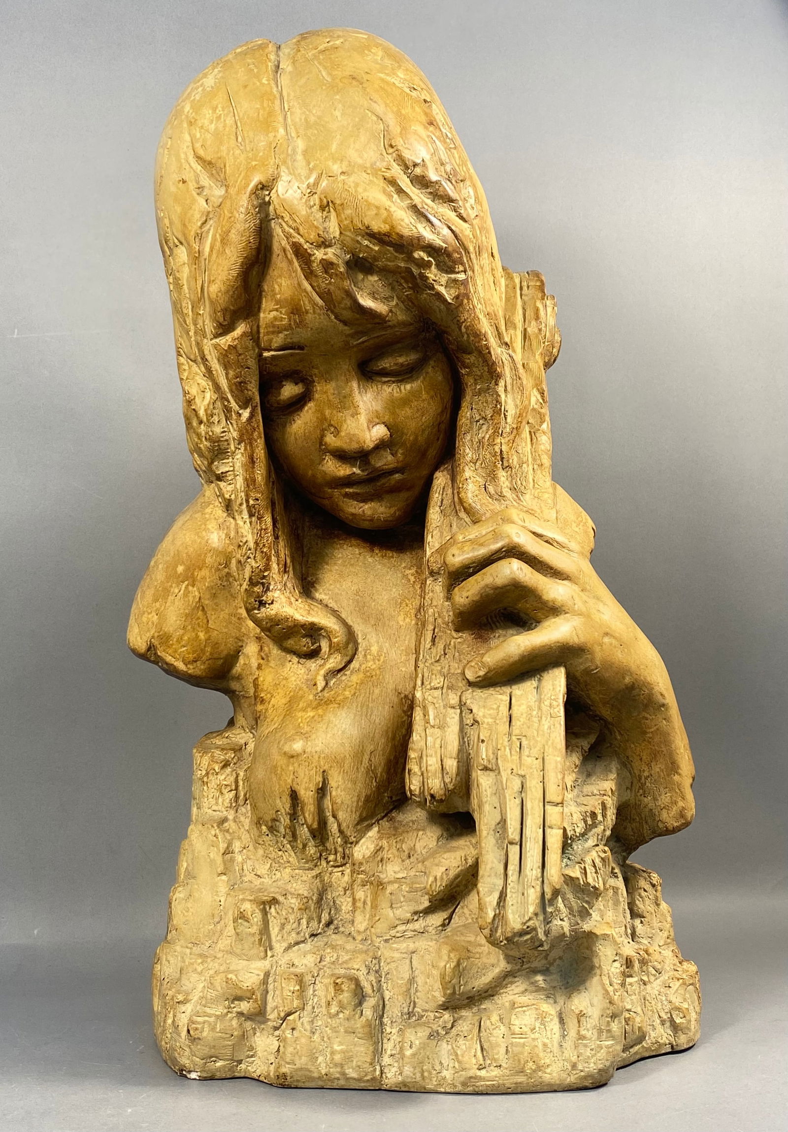 Cattilli for Bayshore Art, Modernist Cast Plaster Sculpture of a Woman with Instrument, 1969: This mid-20th-century cast plaster or composite sculpture depicts a pensive young woman with long, textured hair, her gaze cast downward as she grasps the scroll and neck of a stringed instrument. The
