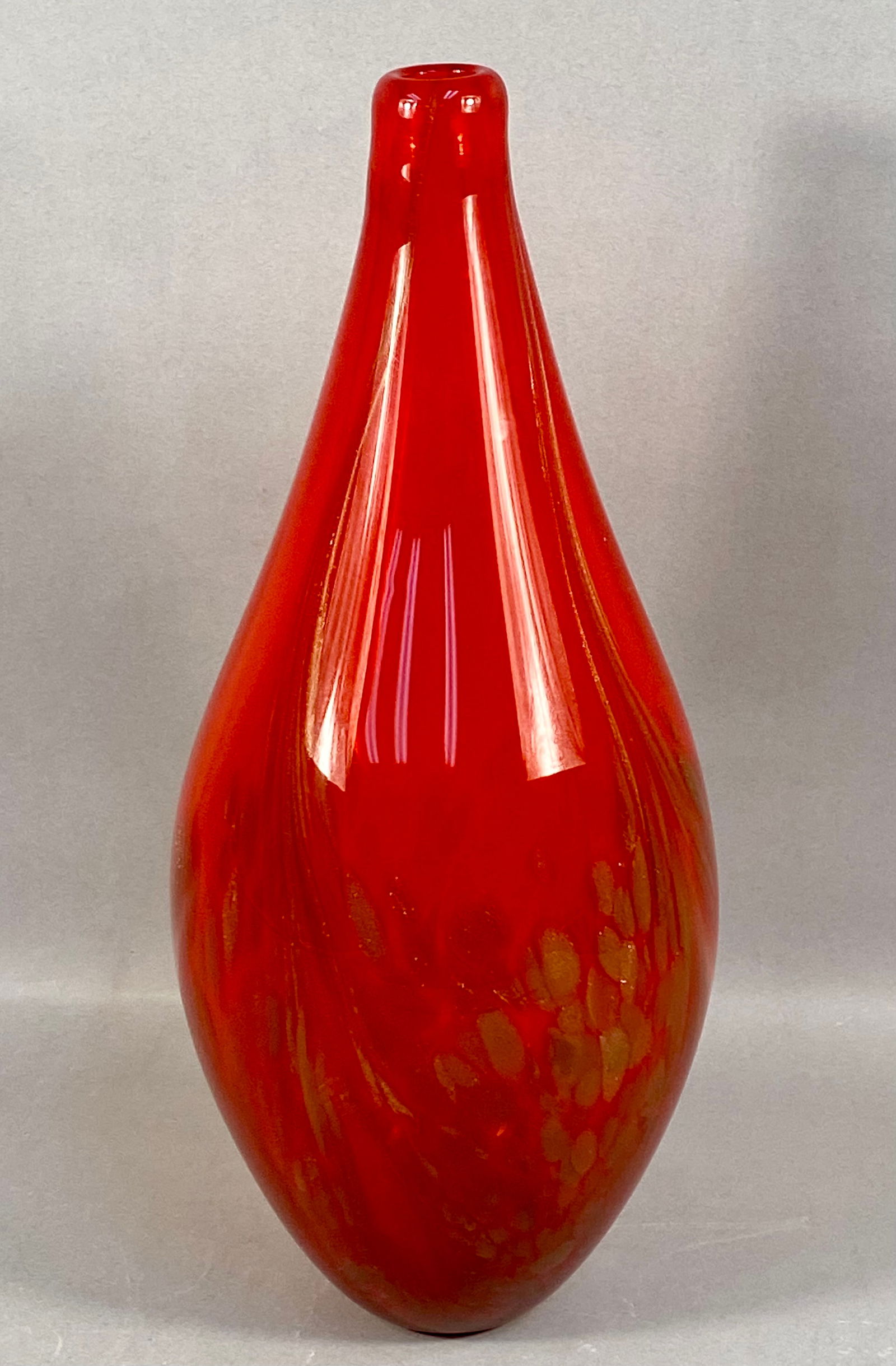 Mid-Century Modern Style Ruby Red Art Glass Teardrop Vase: A large studio art glass vase featuring an elongated teardrop form. The vessel is composed of translucent ruby red glass. The lower half of the body contains internal gold-tone aventurine flecks and m
