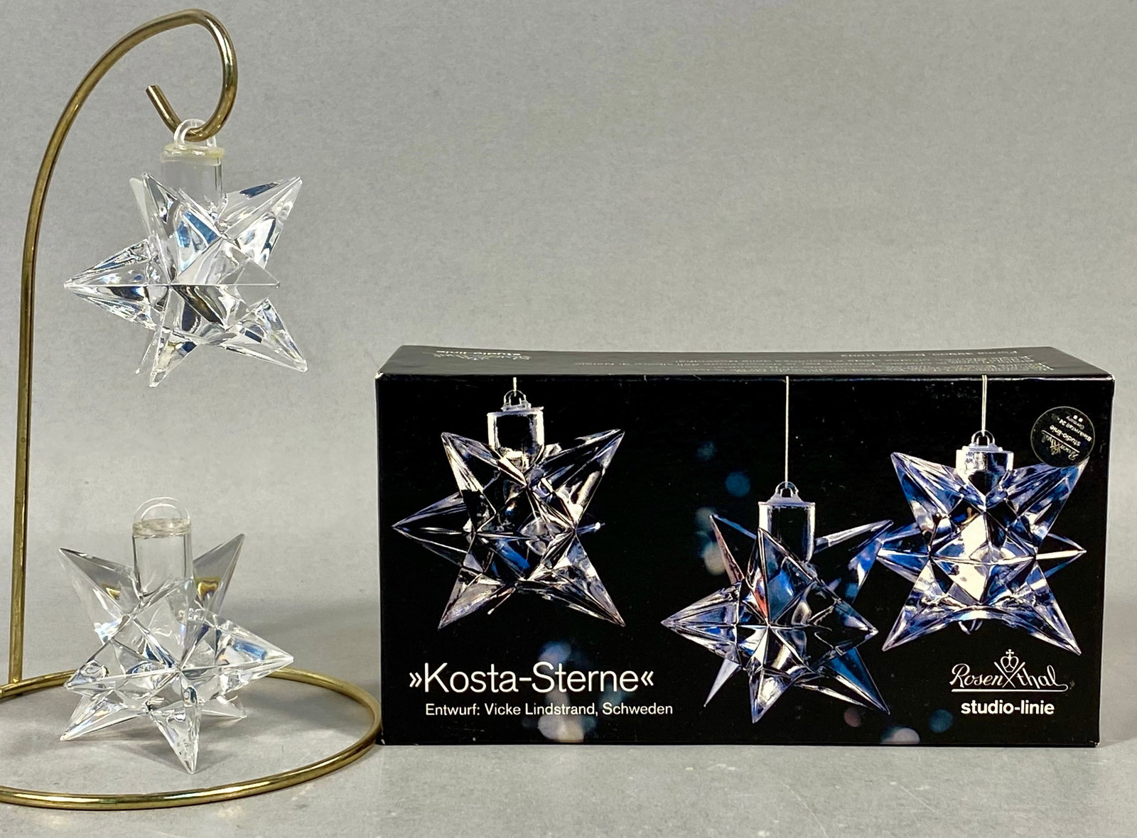 A Pair of Rosenthal Studio-Linie Kosta-Sterne Glass Ornaments Designed by Vicke Lindstrand: A pair of clear faceted glass star ornaments from the Rosenthal studio-linie collection. These ornaments, titled Kosta-Sterne, were designed by Swedish artist Vicke Lindstrand. Each ornament features