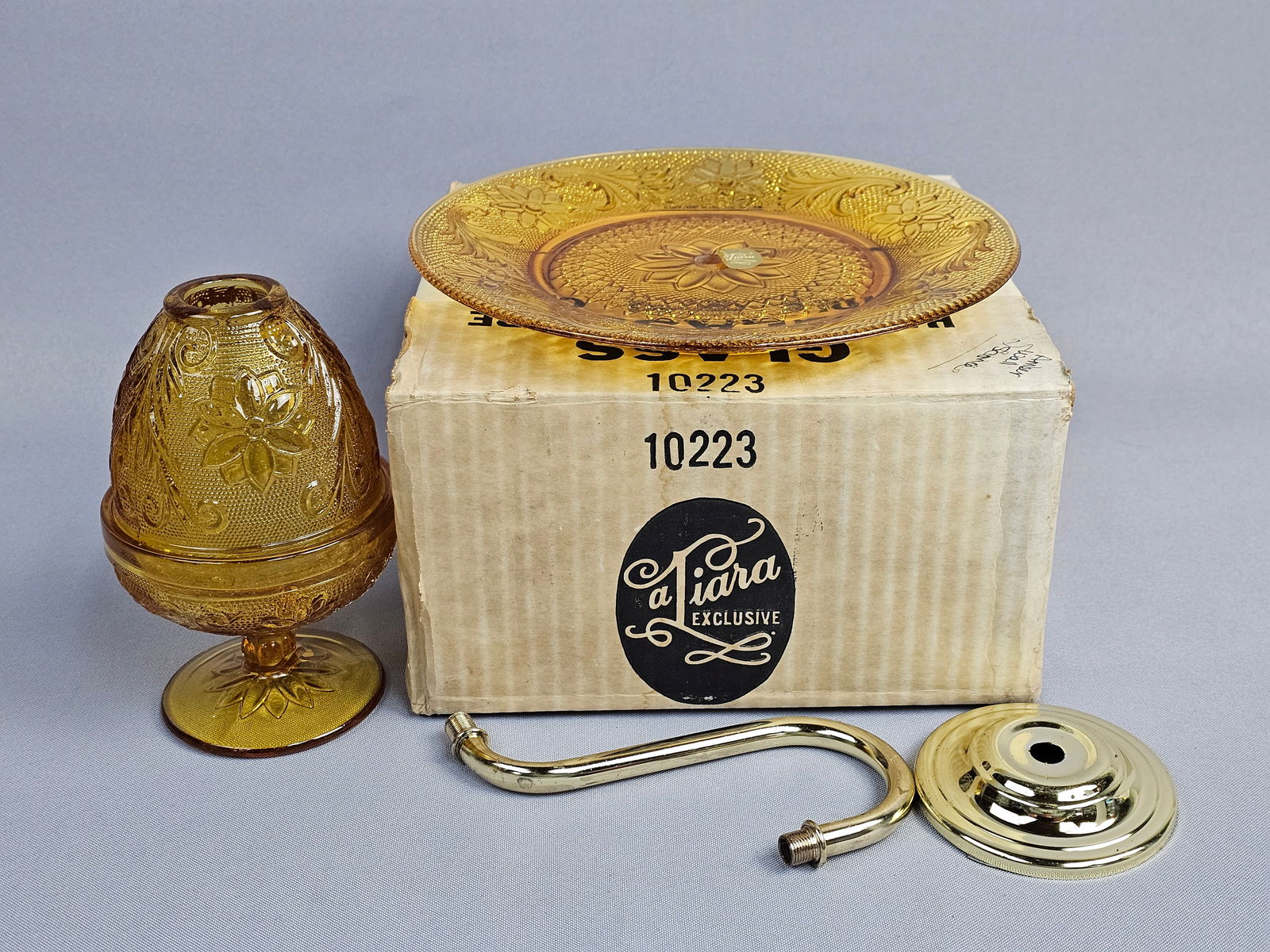 Tiara Exclusives Amber Glass Sandwich Pattern Wall Sconce Set: A Tiara Exclusives wall sconce set in the Sandwich pattern, manufactured in amber-colored pressed glass. The original manufacturer's box, marked with item number 10223, and the original assembly instr