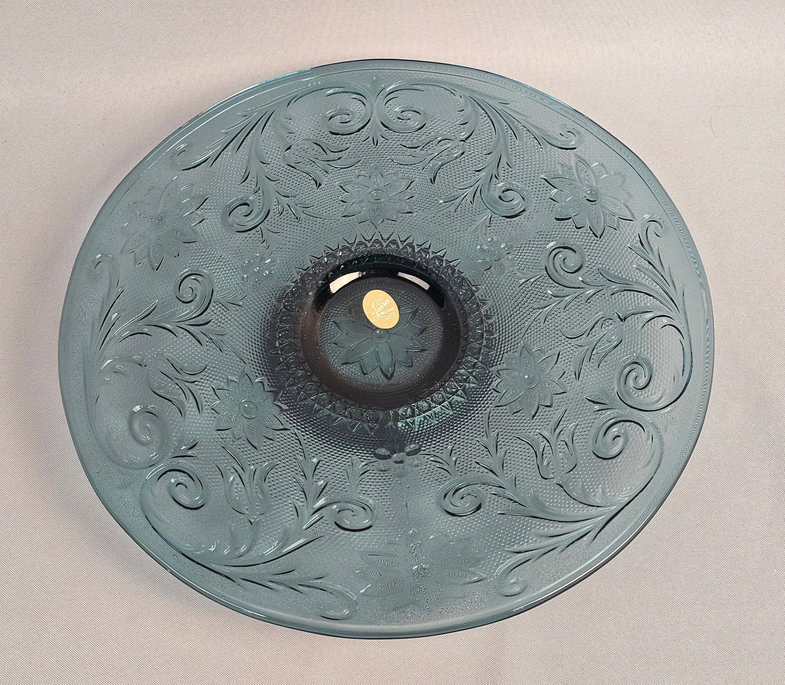 Tiara Exclusives Sandwich Pattern Colonial Blue Glass Platter: This pressed glass platter is executed in the Sandwich pattern for Tiara Exclusives. The glass is a teal blue shade referred to as Colonial Blue or Bicentennial Blue. The design features a stippled ba