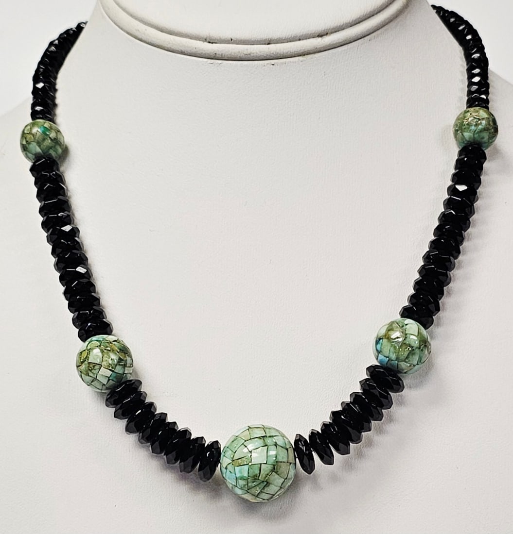 Sterling Silver Faceted Black Bead & Green Mosaic Bead Necklace: A single-strand necklace featuring graduated faceted black beads and five spherical green mosaic-style beads. The mosaic beads are constructed with a tiled pattern of light and dark green segments. Th