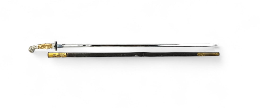 Vintage Officer's Dress Sword with Sheath: Overall Length: 34.5 inches The blade exhibits scattered pitting, surface oxidation, and minor nicks to the edge. The plating on the pommel and guard shows wear and tarnish. The grip covering is