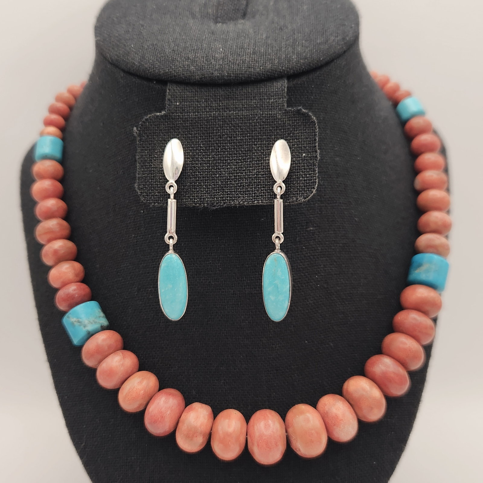 Sterling Turquoise & Coral Set: This collection includes a Desert Rose Trading beaded necklace and a pair of coordinating dangling earrings. The necklace is composed of turquoise & coral beads. The necklace is finished with ster