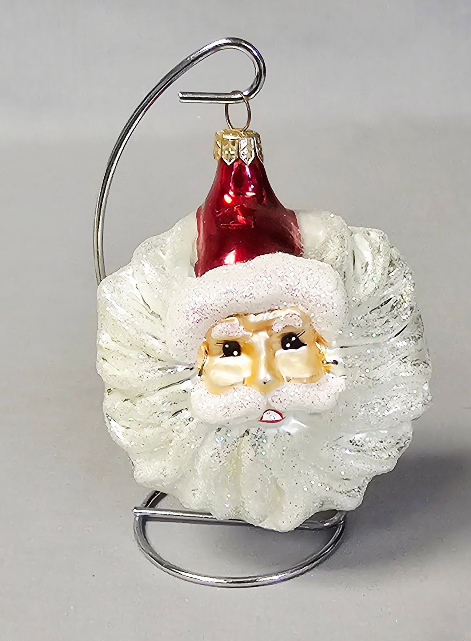 Christopher Radko Winter Winds Santa Claus Ornament: Stand not included. This lot features a large hand-blown glass Christmas ornament attributed to the Winter Winds pattern by Christopher Radko. The ornament is in good overall condition with no visible
