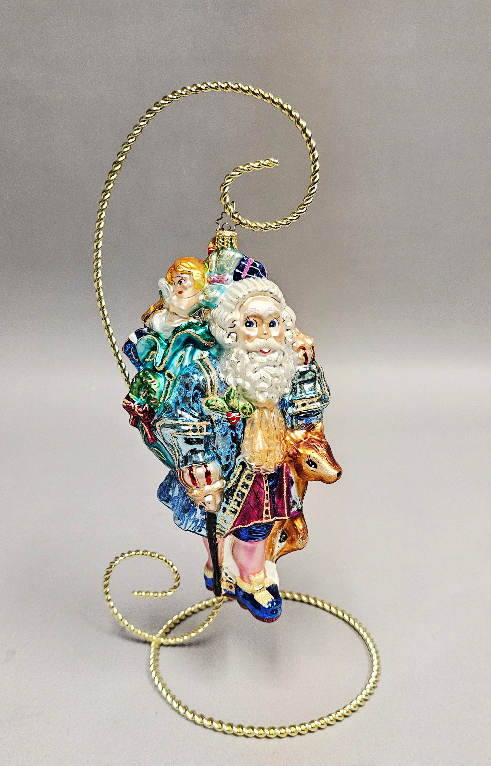 Christopher Radko Versailles Minuet Santa Glass Ornament: Stand not included. This large, mouth-blown glass Christmas ornament is part of the Christopher Radko Santa Through the Centuries collection, titled Versailles Minuet. The design depicts a late 17th-c