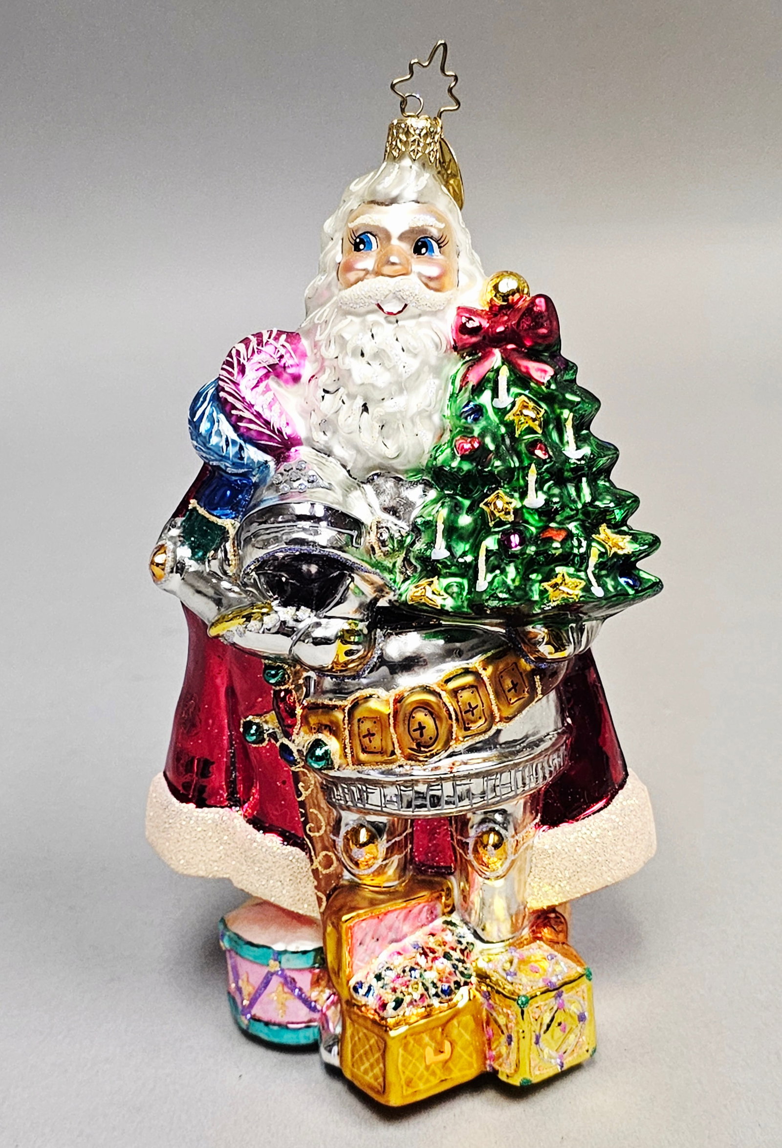 Christopher Radko Christmas Knight Santa Glass Ornament: A Christopher Radko hand-blown glass Christmas ornament titled Christmas Knight, from the Santa through the Centuries collection. It is topped with the signature Radko gold-toned star-shaped hanging l