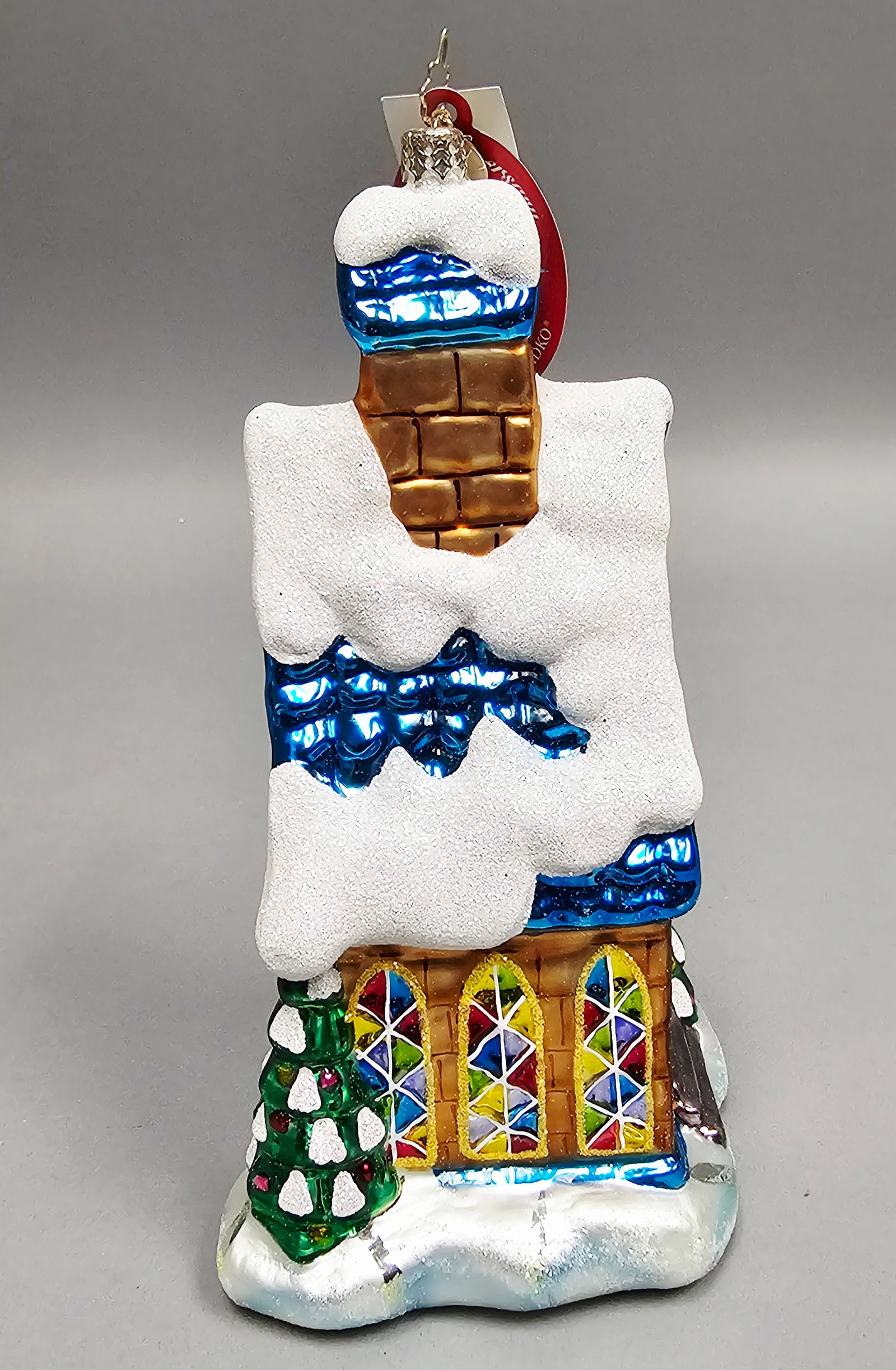 Christopher Radko Midnight Mass Glass Church Ornament: Christopher Radko 20th Anniversary collection glass Christmas ornament titled Midnight Mass, model number 1011757. The piece retains its original manufacturer tags, including a red oval 20th Anniversa