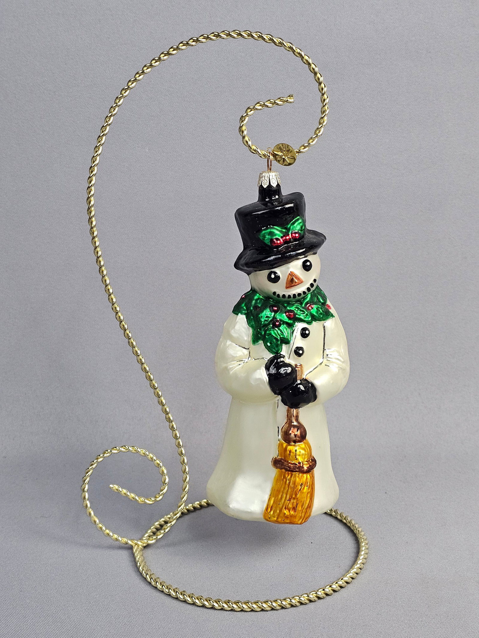 Christopher Radko Smiling Snow Friend Glass Snowman Ornament: This hand-blown and hand-painted glass Christmas ornament is produced by Christopher Radko, identified by the trademark embossed eight-pointed starburst on the attached gold-tone metal tag. The orname