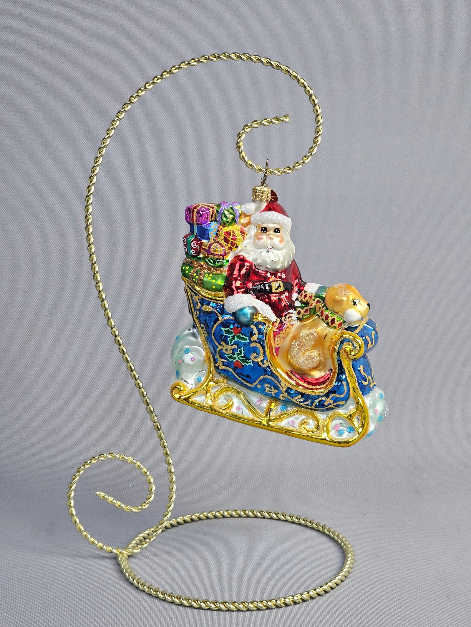 Christopher Radko Magical Sleighride Hand-Painted Glass Christmas Ornament: This Christopher Radko hand-painted glass Christmas ornament is titled Magical Sleighride and was produced as a Saks Fifth Avenue exclusive. The ornament depicts Santa Claus in a blue and gold sleigh 