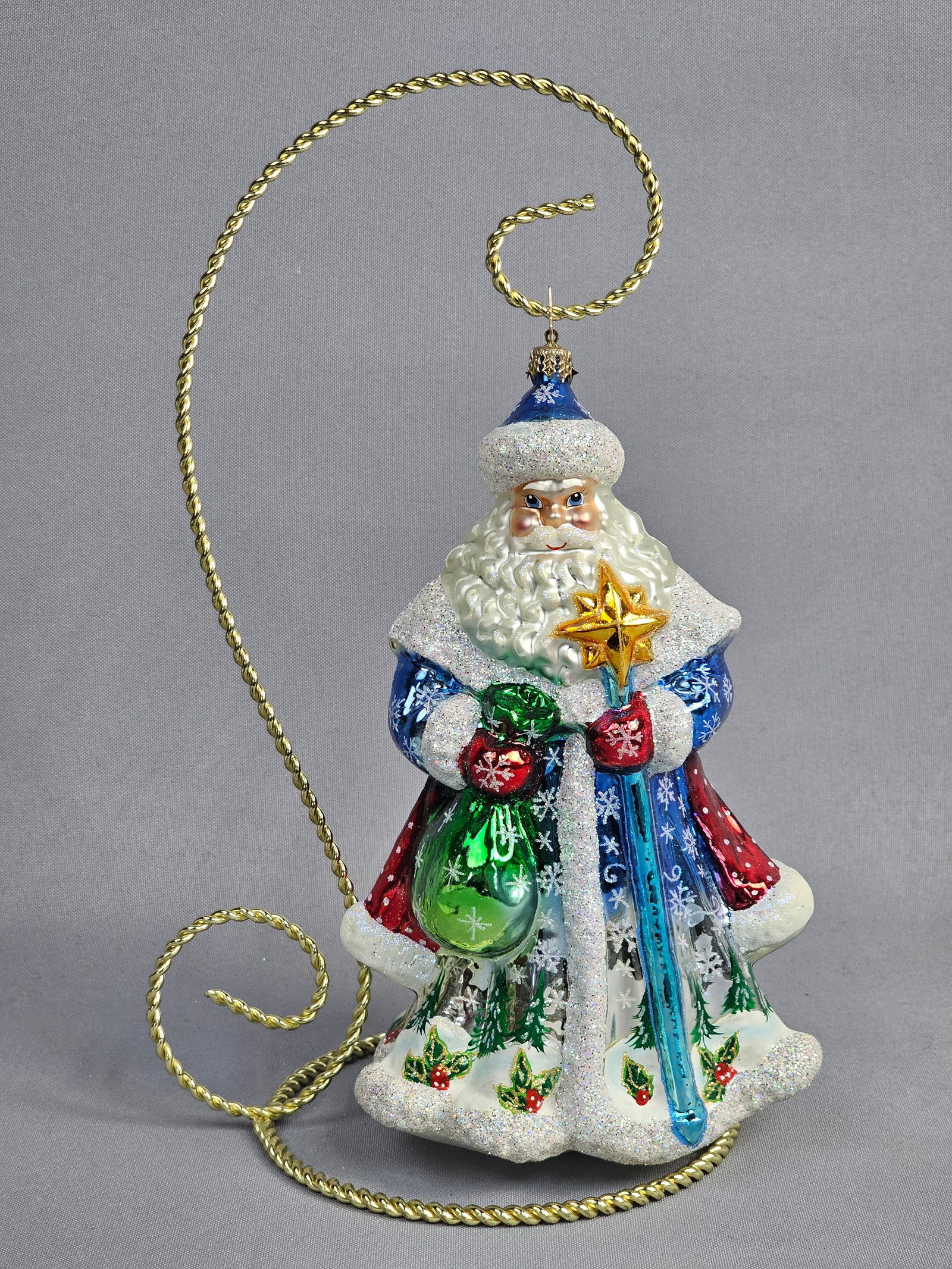 Christopher Radko Folk Festive Claus Blown Glass Santa Christmas Ornament: A mouth-blown glass Christmas ornament by Christopher Radko, identified as the Folk Festive Claus pattern. The piece is crafted from silvered glass and finished with hand-painted polychrome enamels an