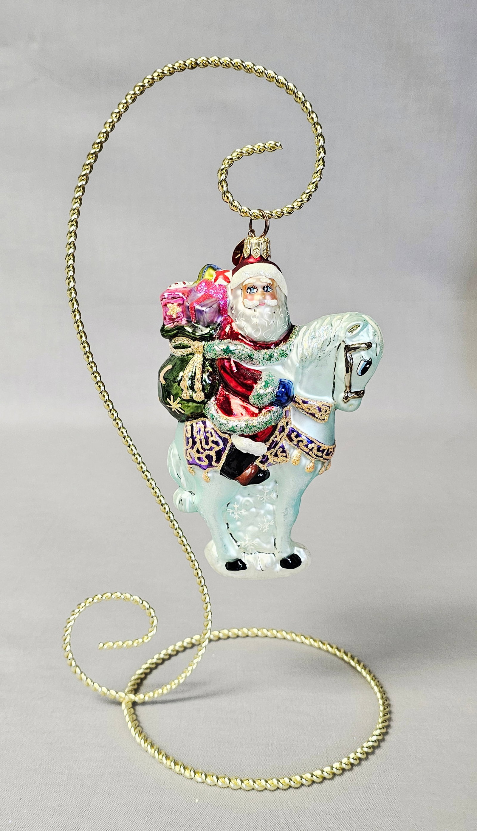 Christopher Radko Glass Santa on Horse Ornament: Stand not included. A hand-blown and hand-painted glass Christmas ornament by Christopher Radko depicting Santa Claus riding a white horse. The ornament appears to be in very good condition with no vi