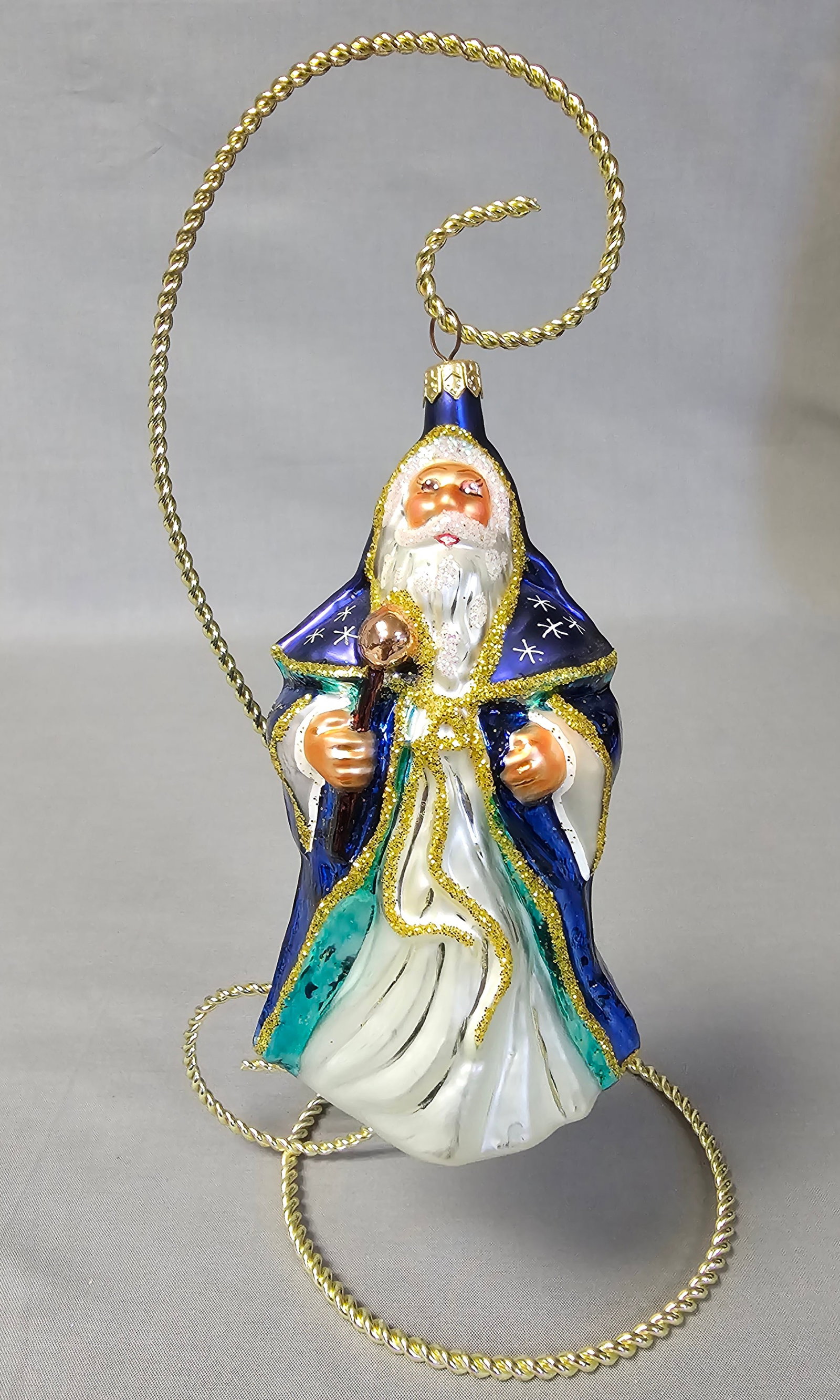 Christopher Radko Glass Celestial Father Christmas Ornament: Stand not included. The ornament depicts a traditional Father Christmas or Saint Nicholas figure in a celestial theme. The ornament is in excellent condition with no visible chips, cracks, or repairs.