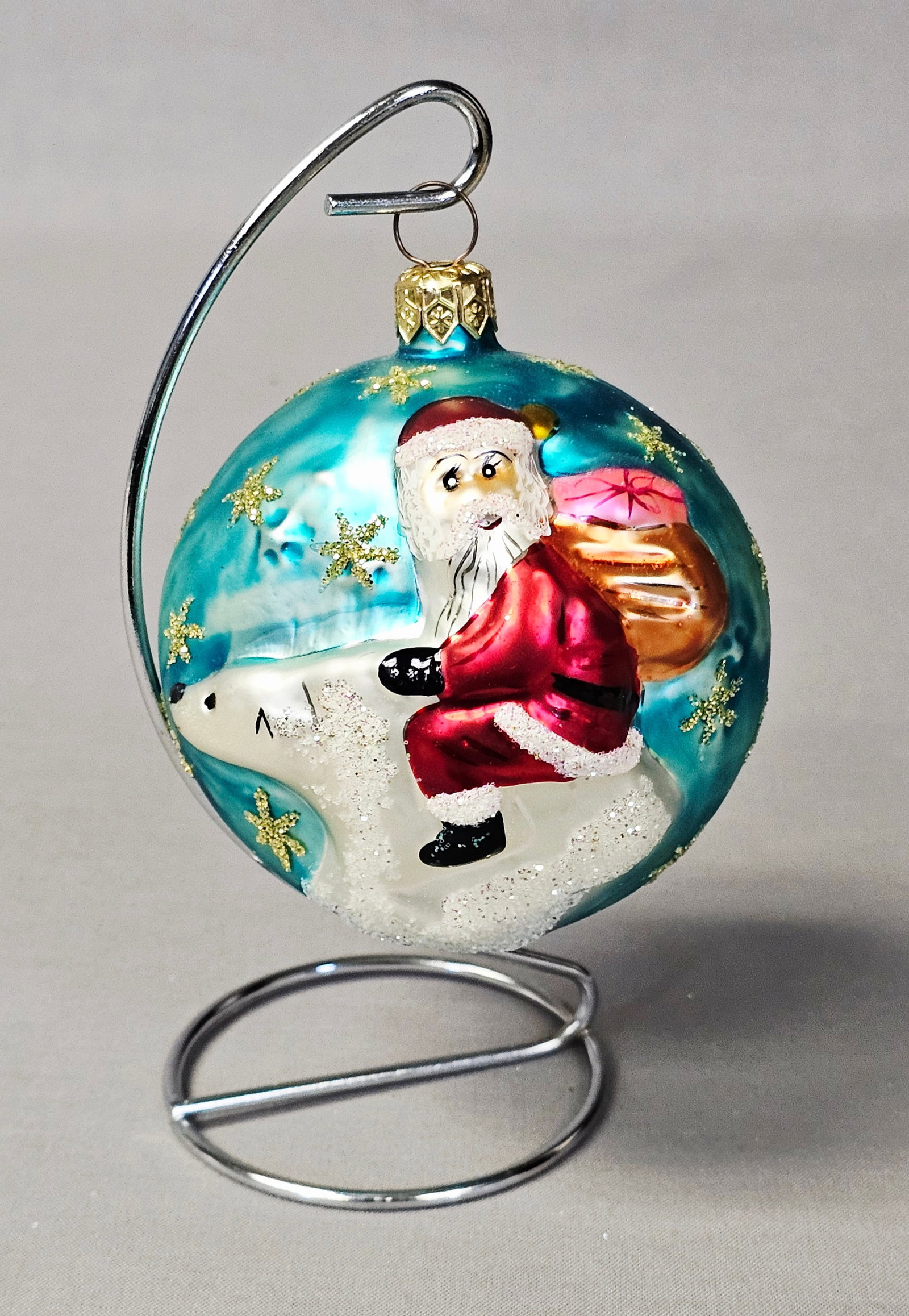 Christopher Radko Santa on Polar Bear Glass Ornament: Stand not included. This hand-blown glass Christmas ornament is attributed to Christopher Radko and features the St. Nicks Winter Tale motif. The ornament is in excellent condition. There are no visib