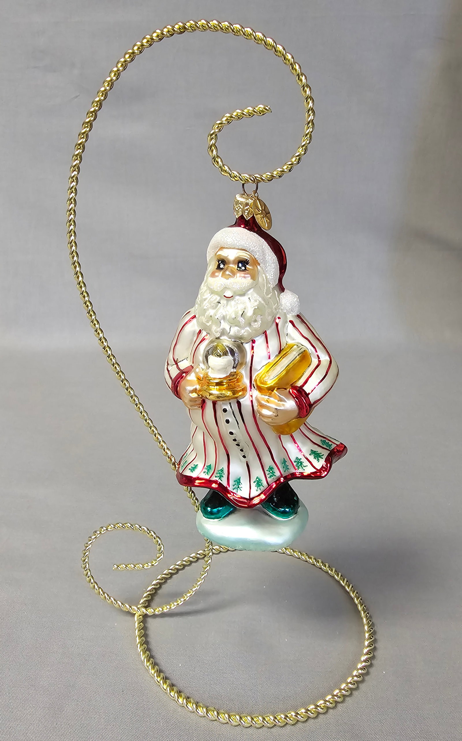 Christopher Radko Glass Santa Claus Ornament: Stand not included. A mouth-blown glass Christmas ornament by Christopher Radko depicting Santa Claus in a robe. The ornament is in excellent condition with no visible chips, cracks, or loss of paint.