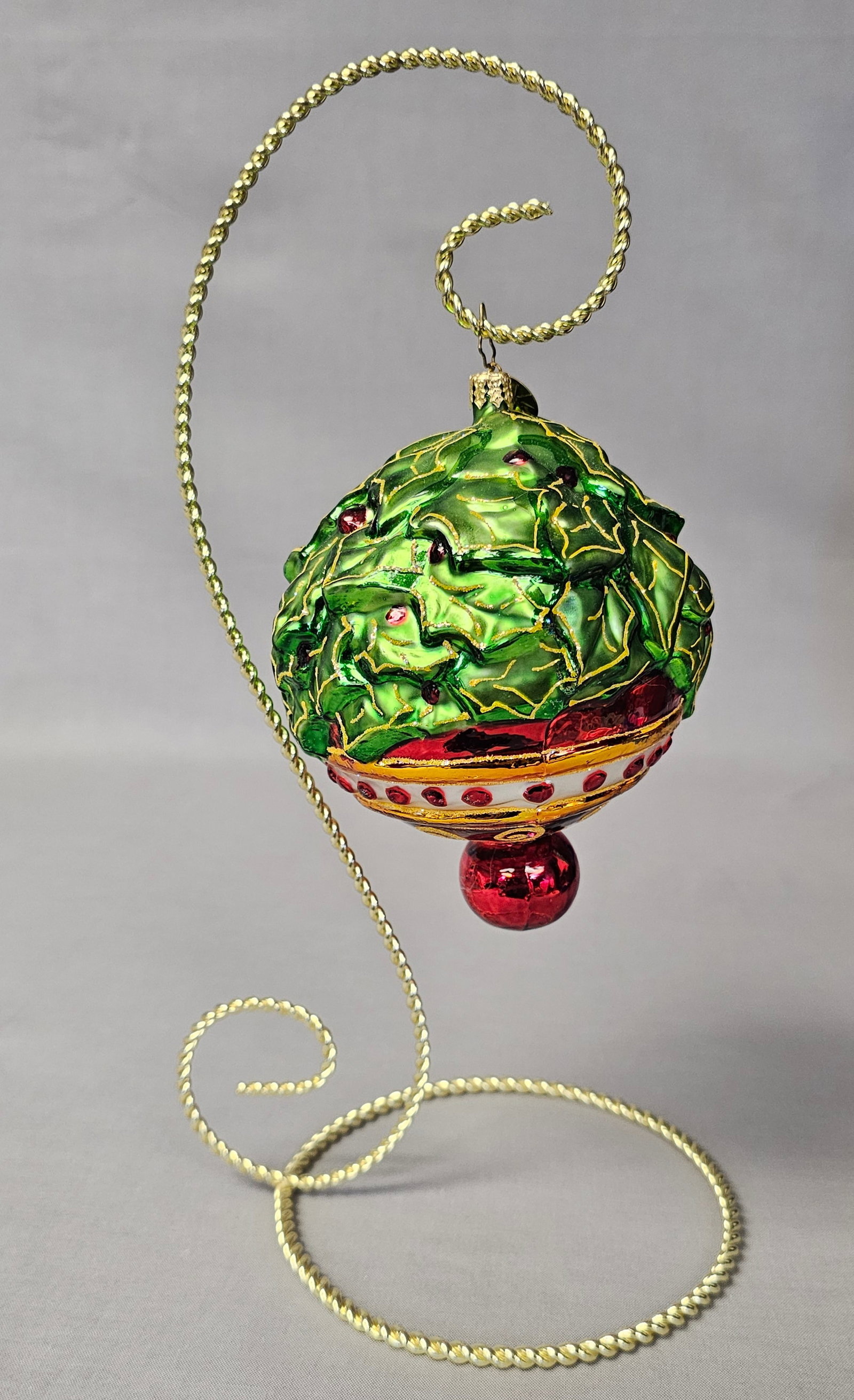 Christopher Radko Holly Frost Glass Ornament: Stand not included. A Christopher Radko mouth-blown glass Christmas ornament in the retired Holly Frost pattern, model number 97-135-0. This handcrafted ornament features a large spherical form with t