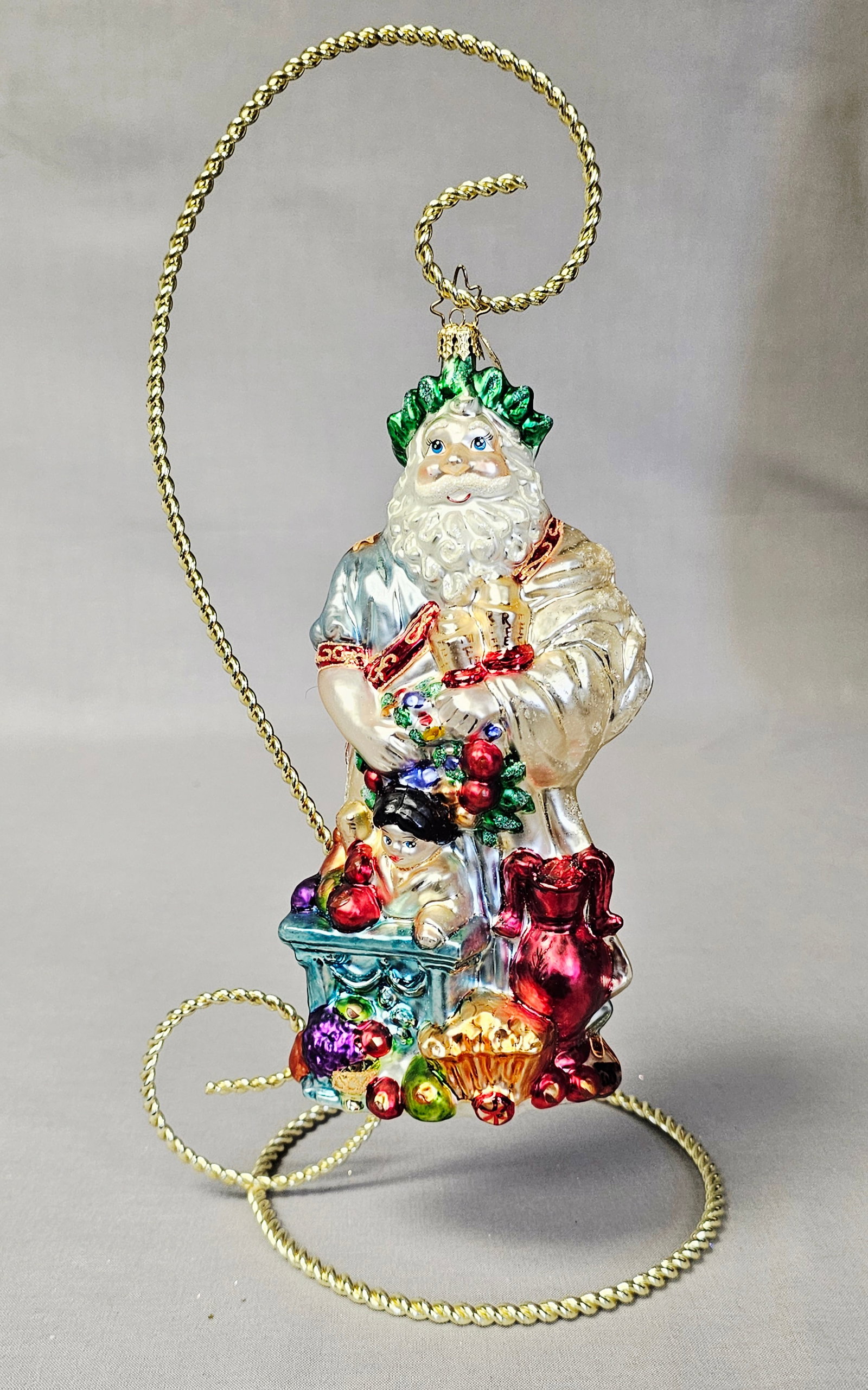 Christopher Radko Classical Father Christmas Ornament: Stand not included. Christopher Radko hand-blown glass ornament from the Santa Through the Centuries collection, depicting a Classical Father Christmas. The figure is styled with Greco-Roman influence