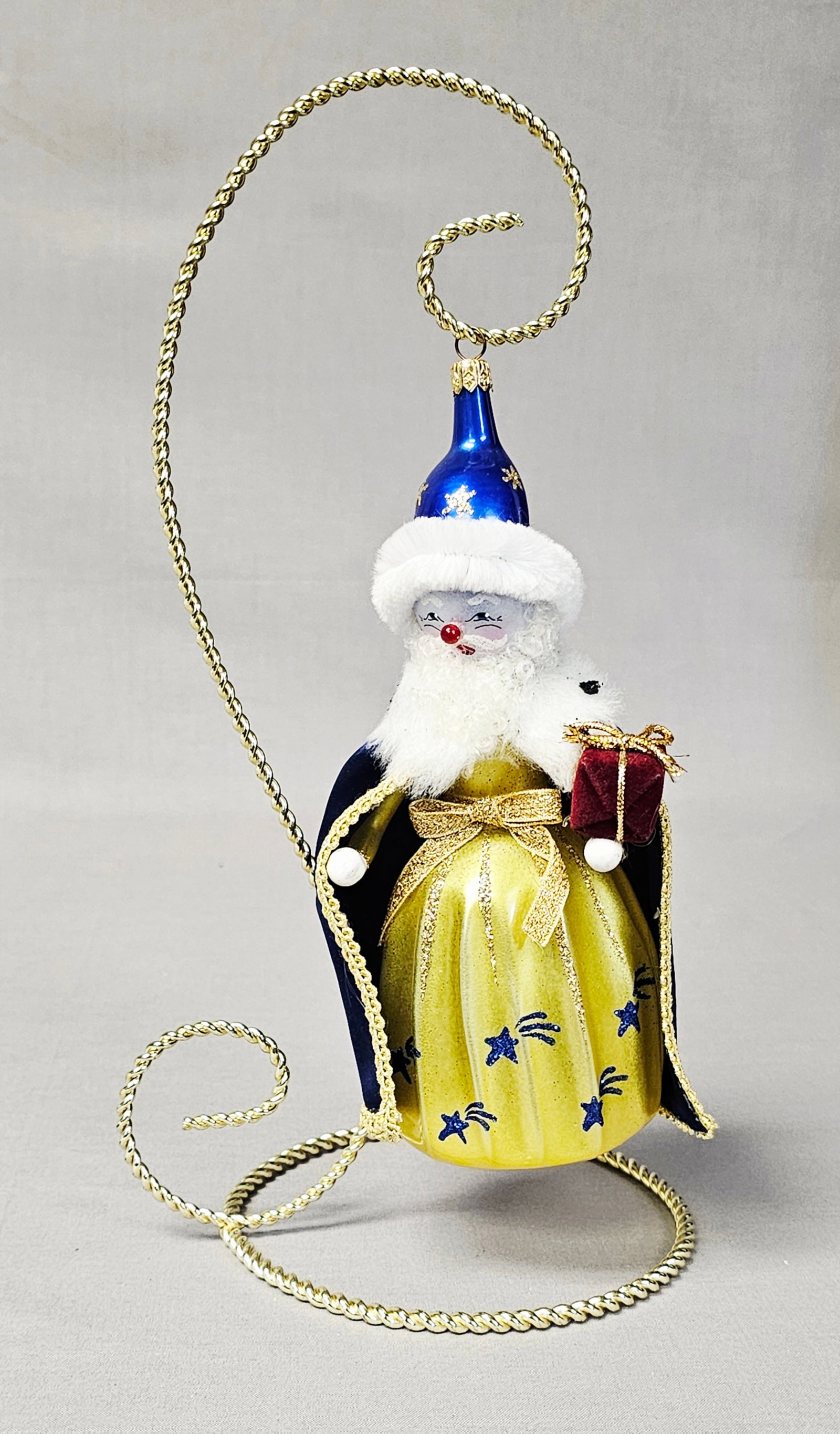 Christopher Radko Grand Presentation Santa Ornament: Stand not included. Christopher Radko in the Grand Presentation design, this multi-media blown glass Christmas ornament depicts a celestial-themed Santa Claus or wizard figure. The ornament is in good