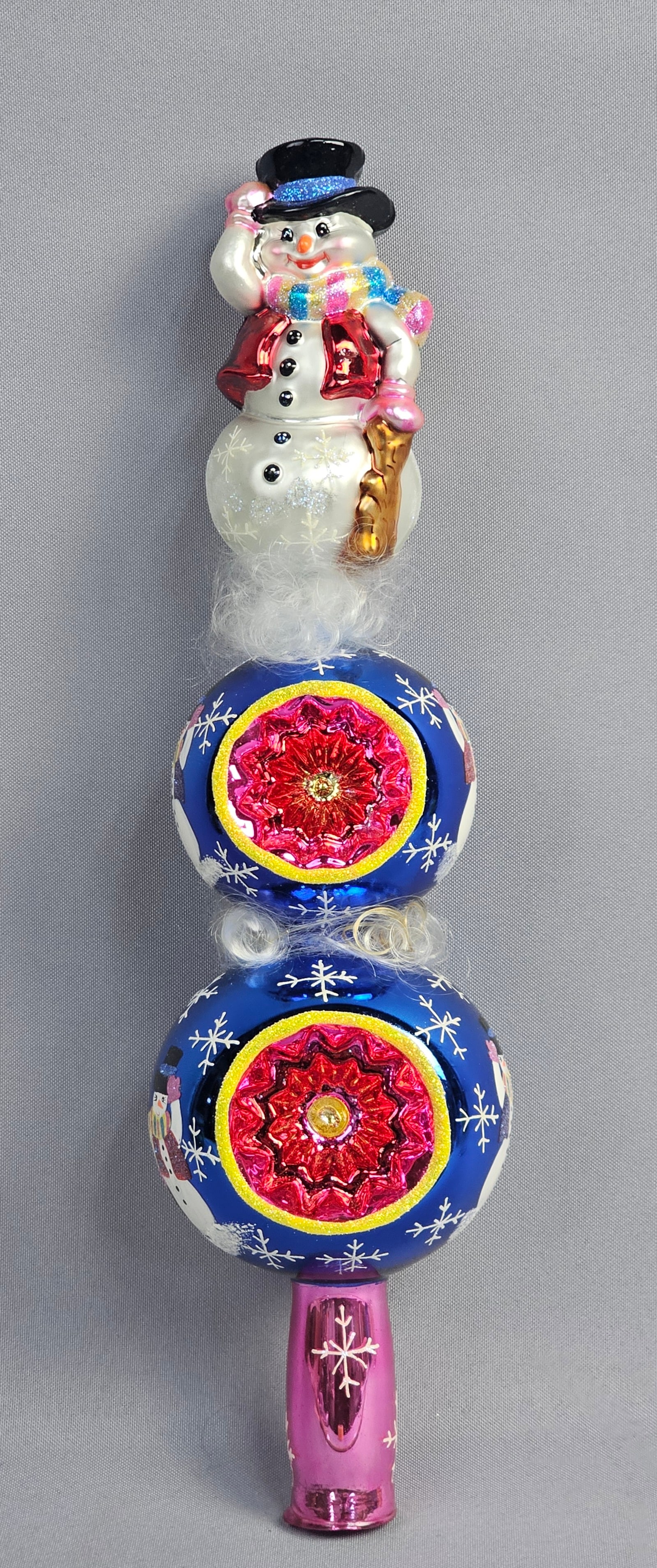 Christopher Radko Attributed Snowcap Snowman Glass Tree Topper Finial: A mouth-blown glass Christmas tree topper finial, attributed to Christopher Radko based on labeling on the accompanying storage box identifying it as Radkos Snowcap Finial 2002. The multi-tiered finia