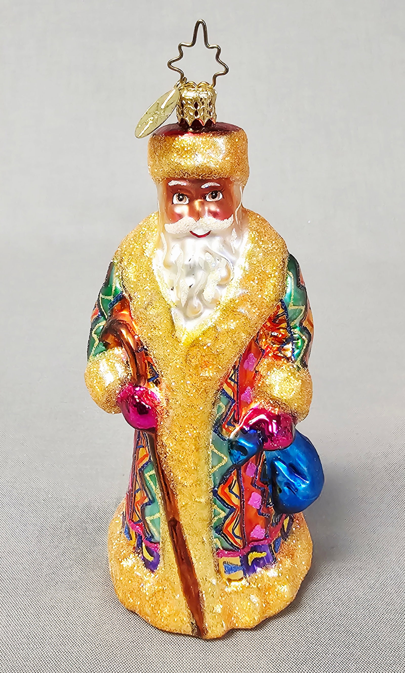 Christopher Radko Russian Santa Glass Ornament: This is a mouth-blown glass Christmas ornament designed by Christopher Radko, depicting a Black Santa Claus or Father Christmas in a style referred to as a Russian Santa. Height: 5.25 inches (to top o
