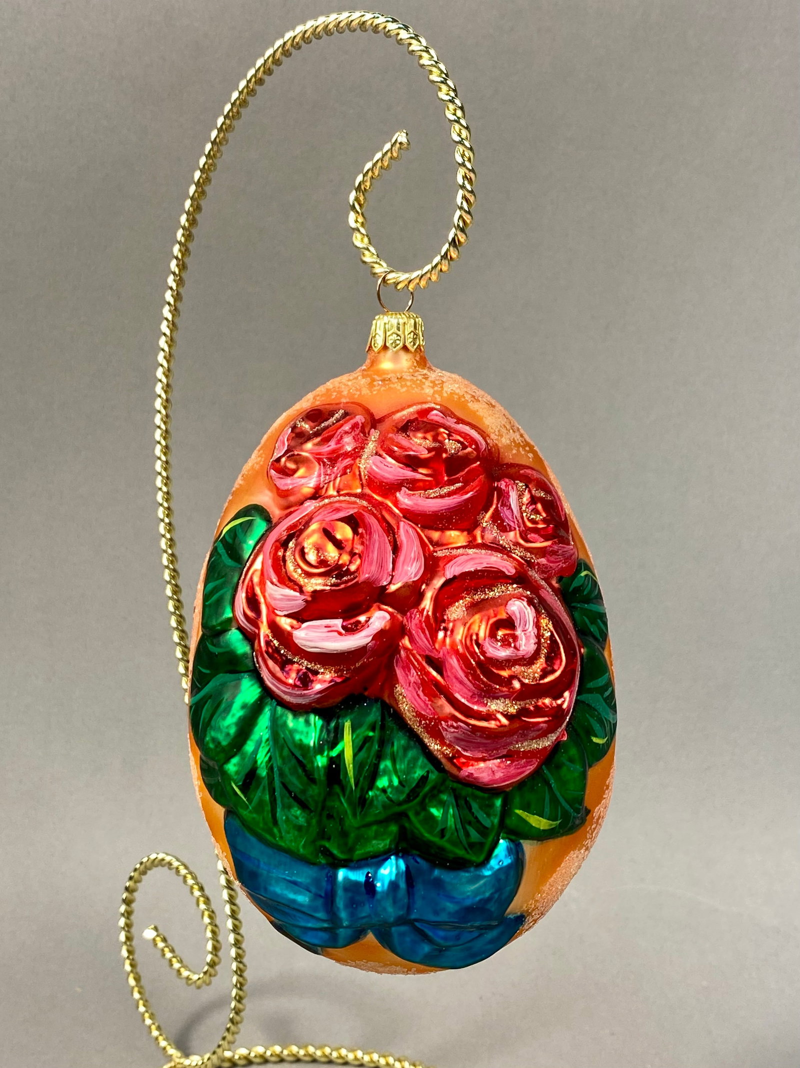 Radko Egg Blossom Hand Painted Glass Ornament: This hand-painted glass egg ornament is a design by Christopher Radko in the Egg Blossom pattern. The ornament is crafted from hand-blown and molded glass, featuring high-relief decoration. The motif 