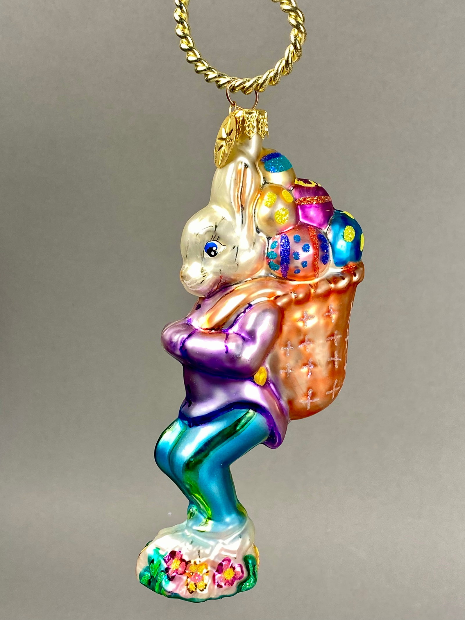 Radko Billy Bunny Goes Shopping Glass Ornament: **Stand Not Included** This hand-painted blown glass ornament is identified as the Billy Bunny Goes Shopping model by Christopher Radko. The figurine depicts an anthropomorphic rabbit in a walking pos