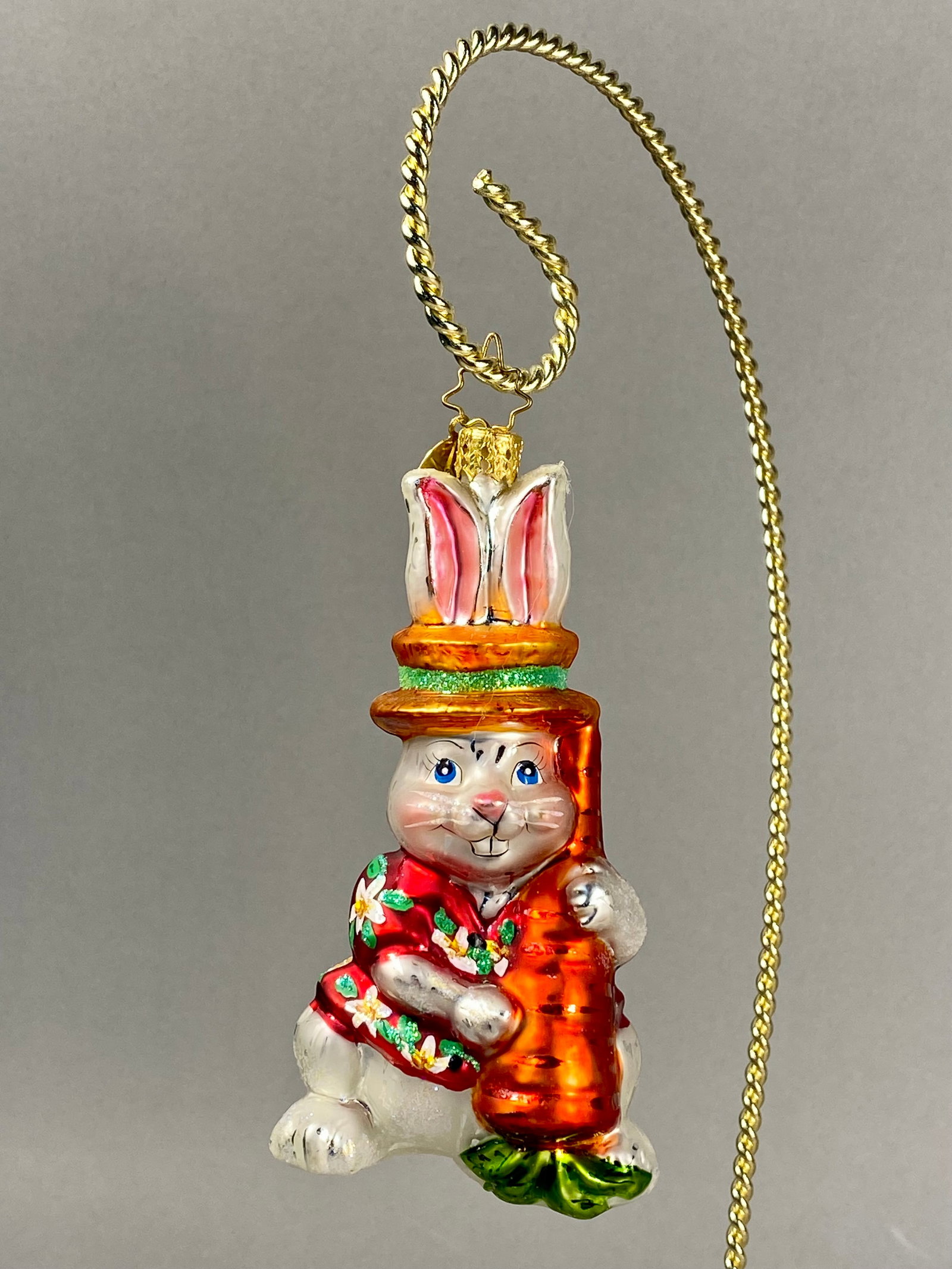 Christopher Radko Hand-Blown Glass Bunny in Hawaiian Shirt Ornament: This hand-blown glass holiday ornament is a product of Christopher Radko, as evidenced by the maker's marks. The whimsical figure depicts a rabbit dressed in a red Hawaiian-style shirt decorated with 