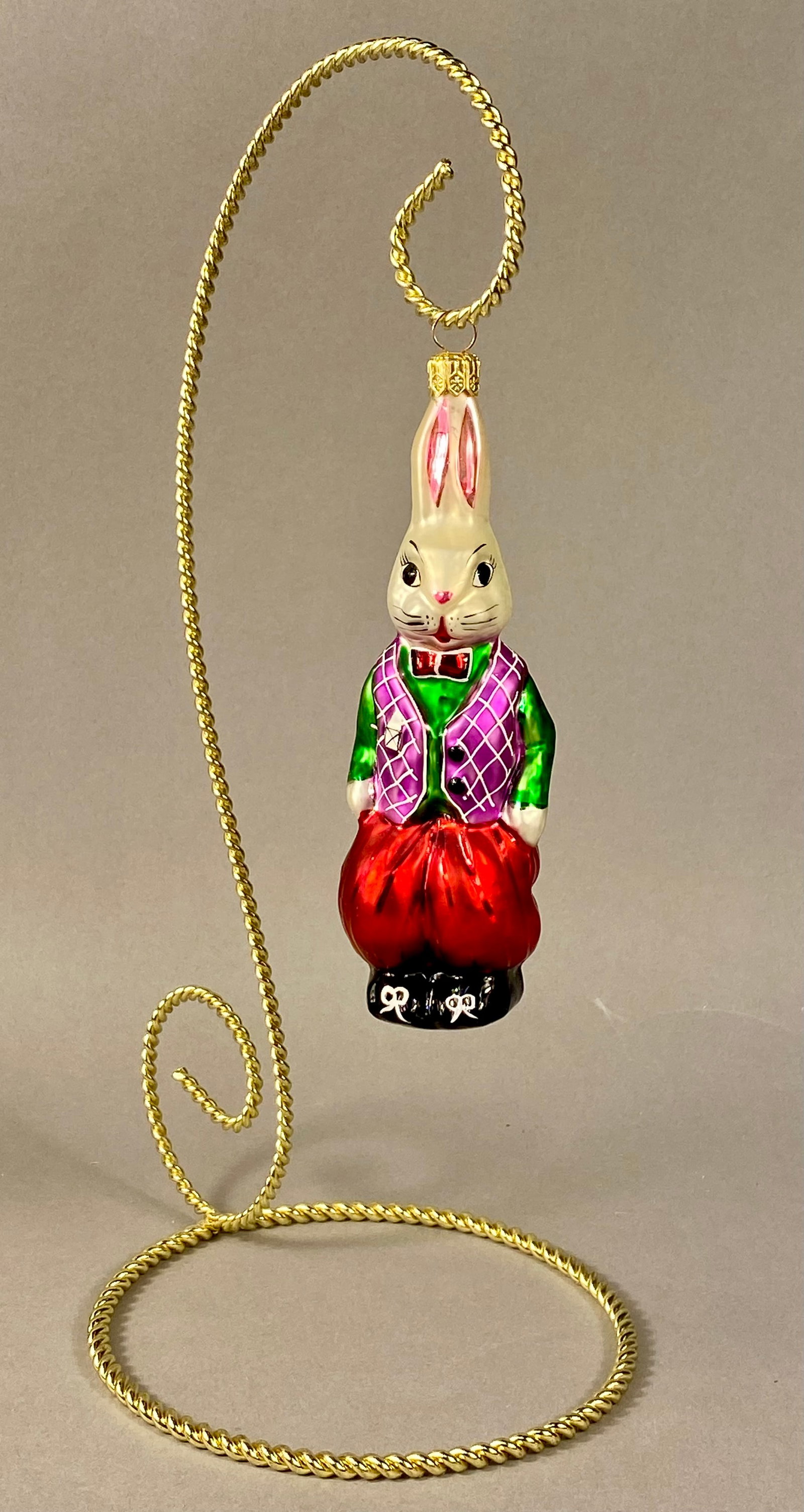 Christopher Radko Billy Bunny Goes Shopping Glass Christmas Ornament: A Christopher Radko hand-blown glass Christmas ornament titled Billy Bunny Goes Shopping. The ornament depicts an anthropomorphic white rabbit in a standing position, dressed in formal attire. The fig